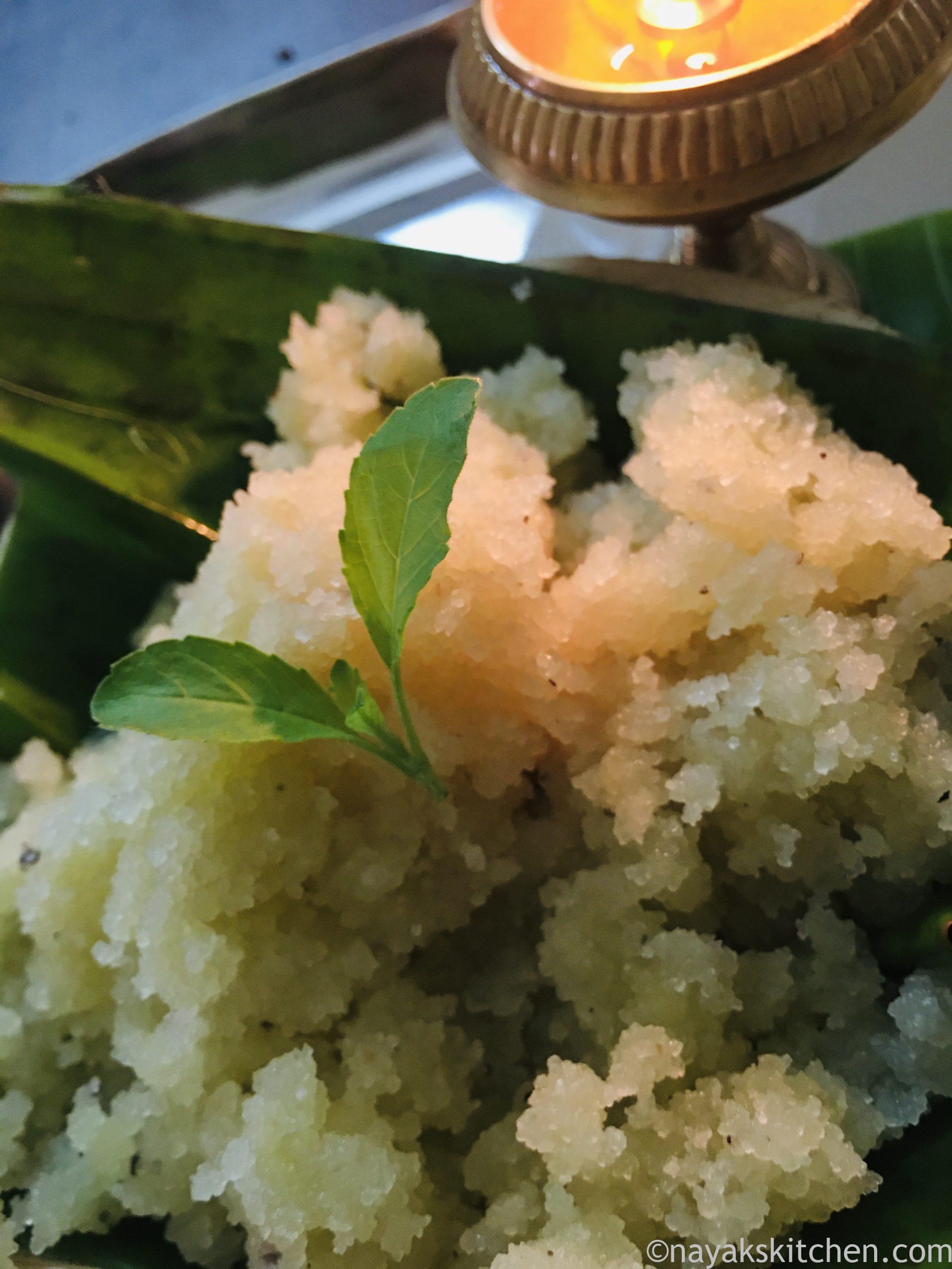 Sheera or Suji ka Halwa on a banana leaf with a lamp lit near it.