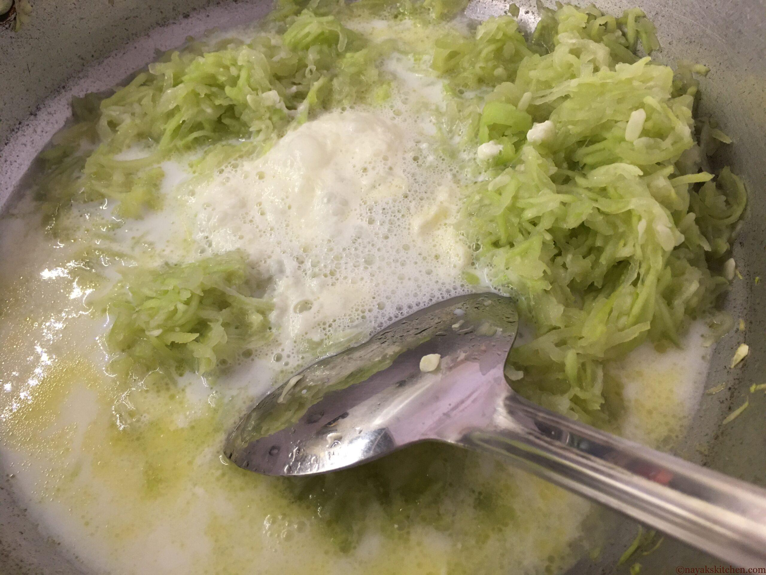 Adding milk to sautéed dudhi