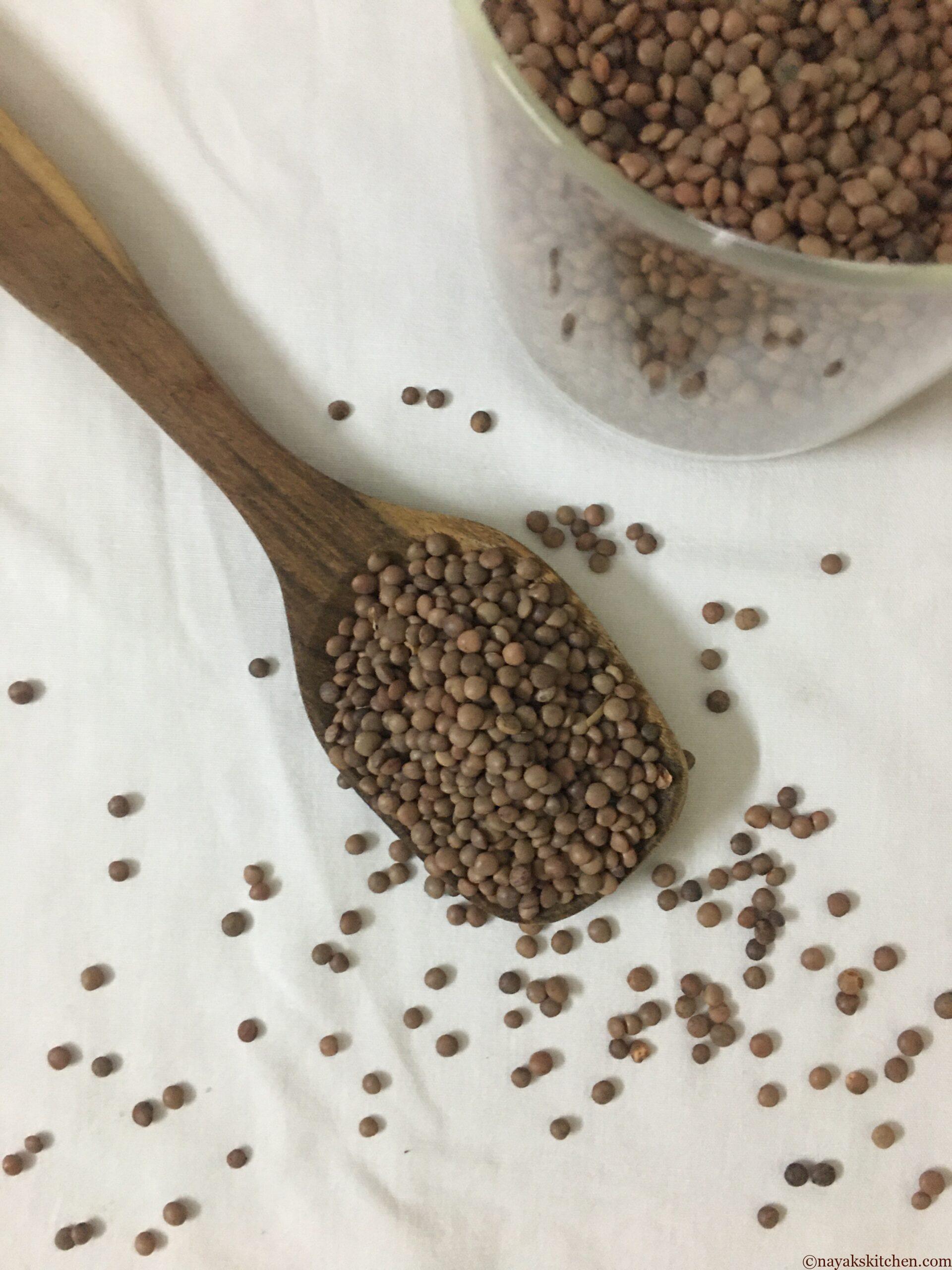 Masoor/Brown Lentil in a wooden spoon and jar