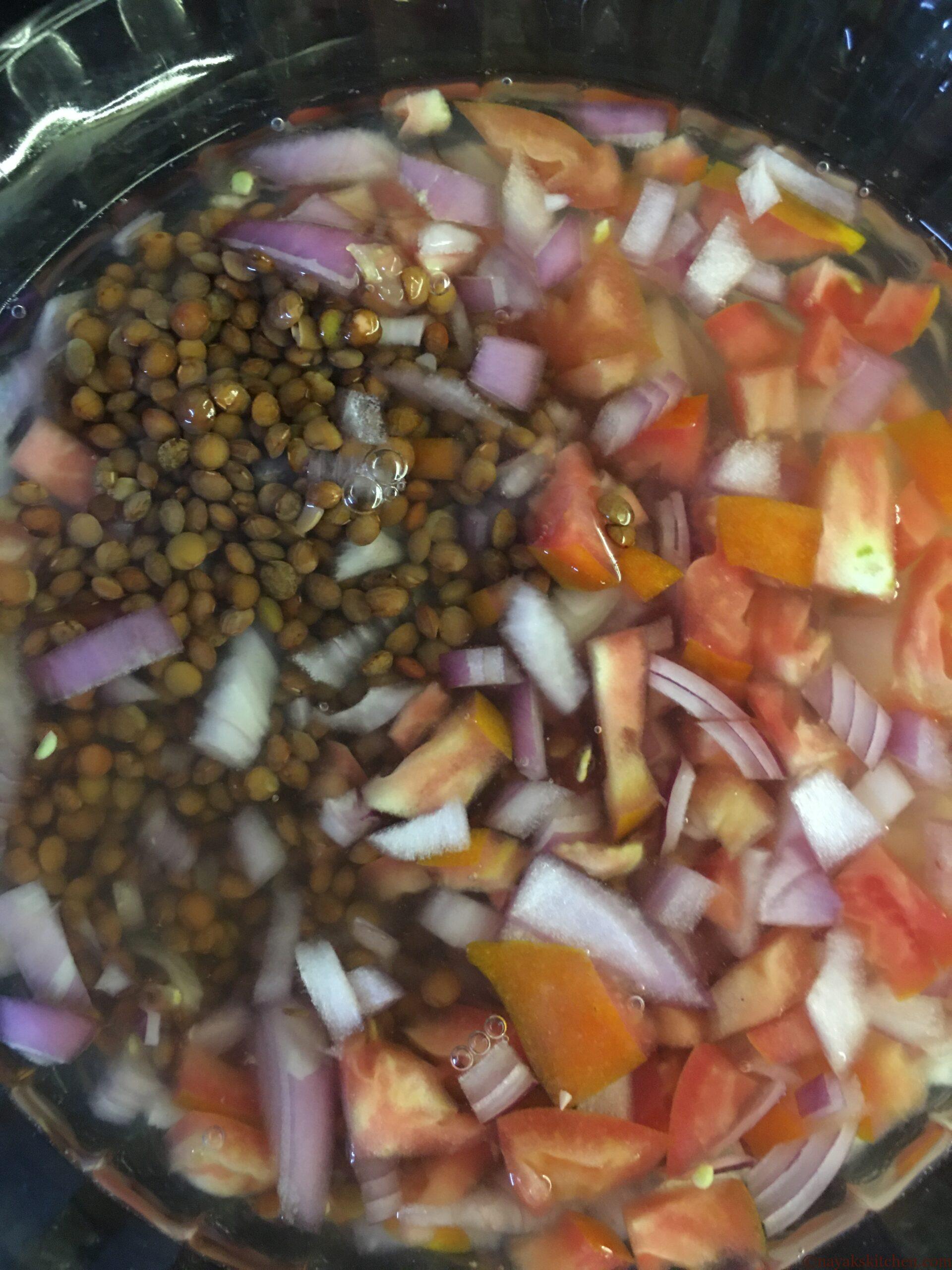Cooking masoor with finely chopped oinion and tomato