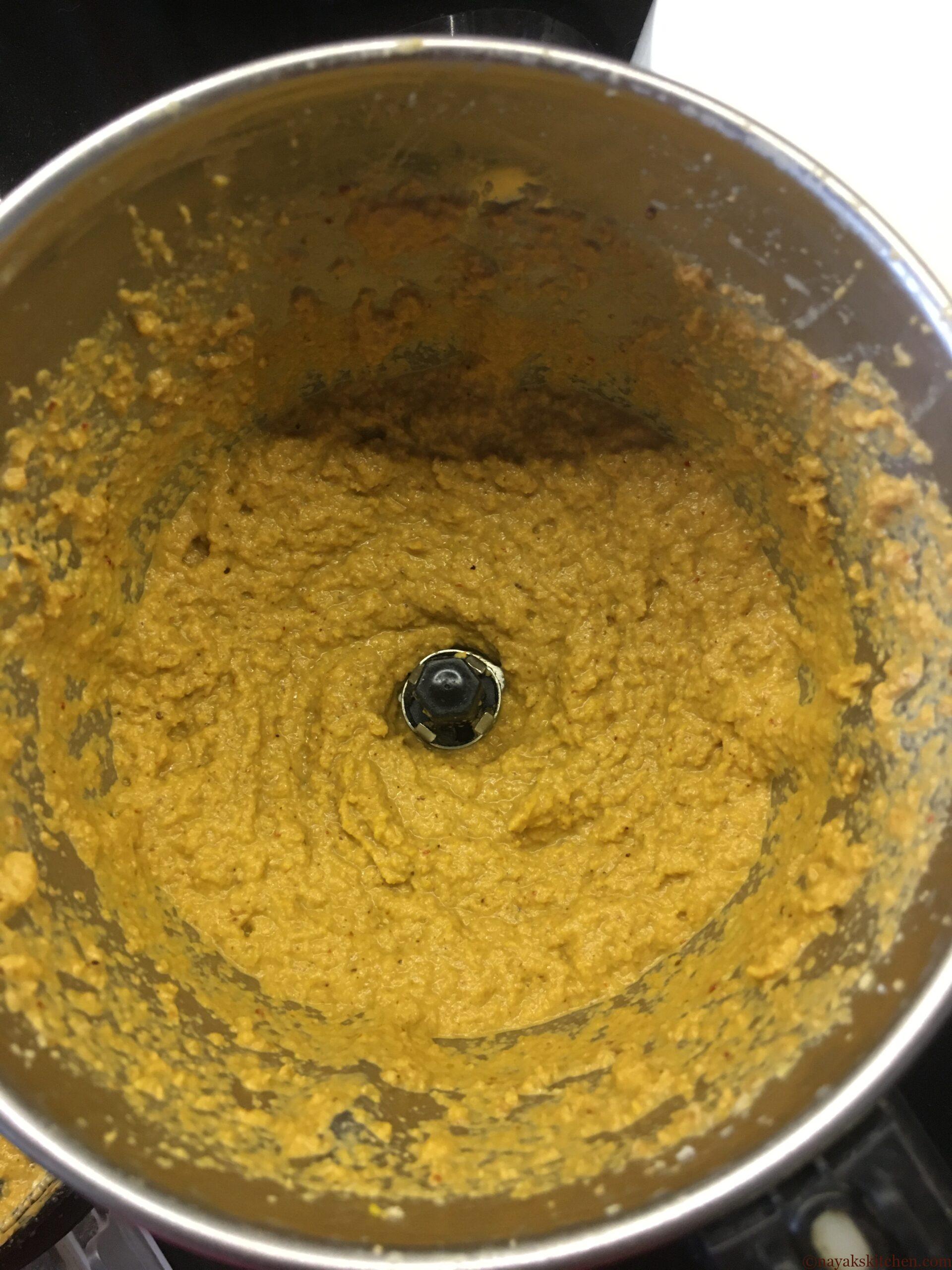 Grinding fried onion, coconut, dry masalas and tamarind to a fine paste in the mixie