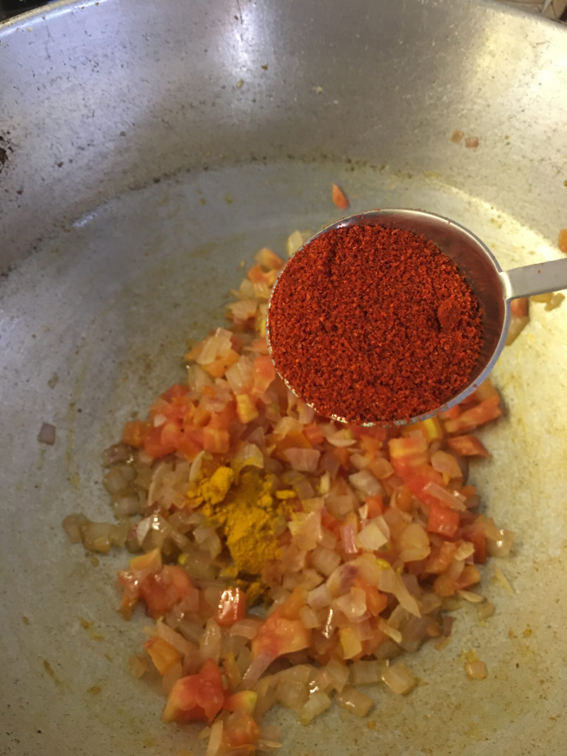 Adding Kashmiri chilli powder