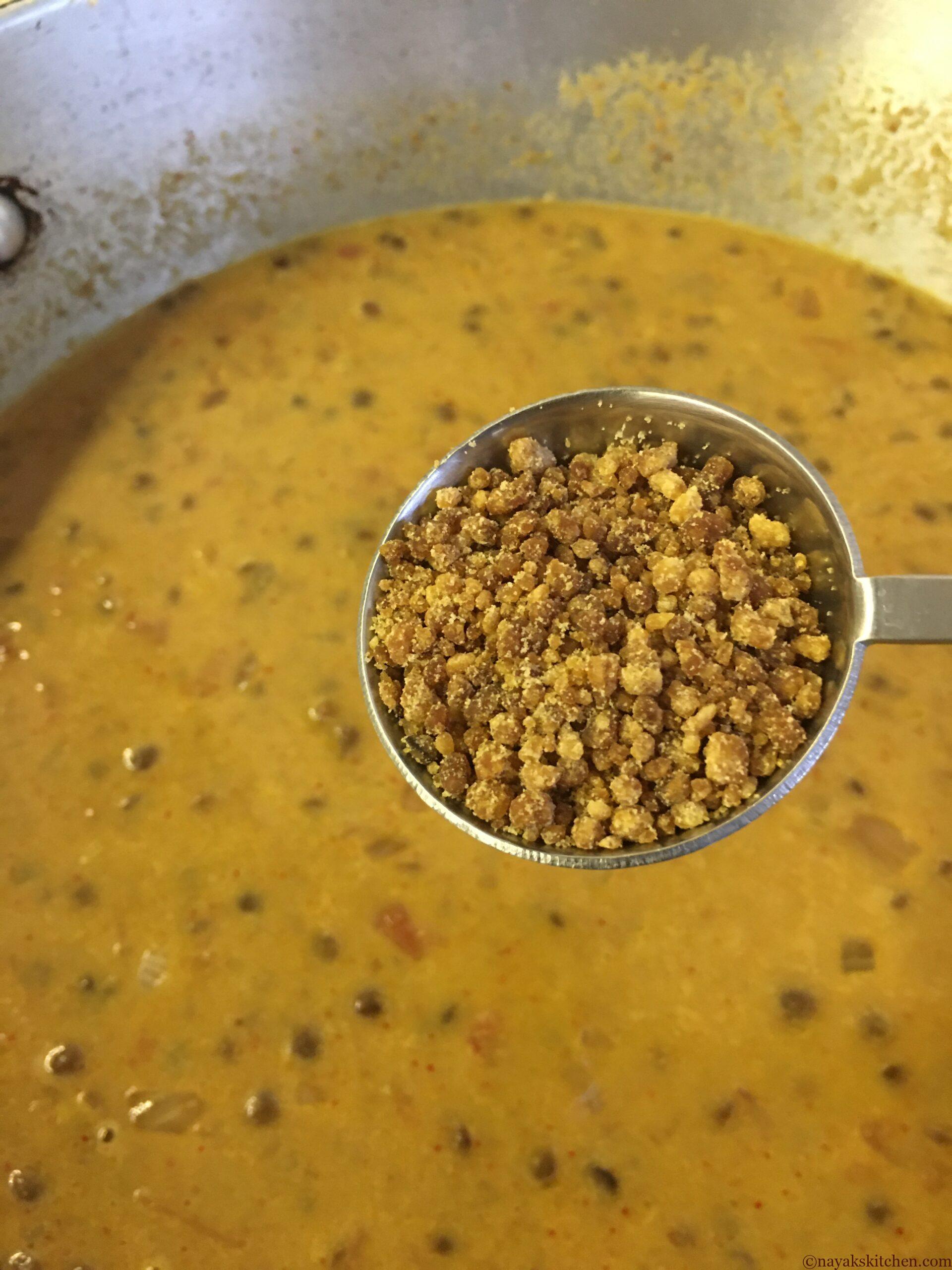 Adding jaggery to masoor tonak