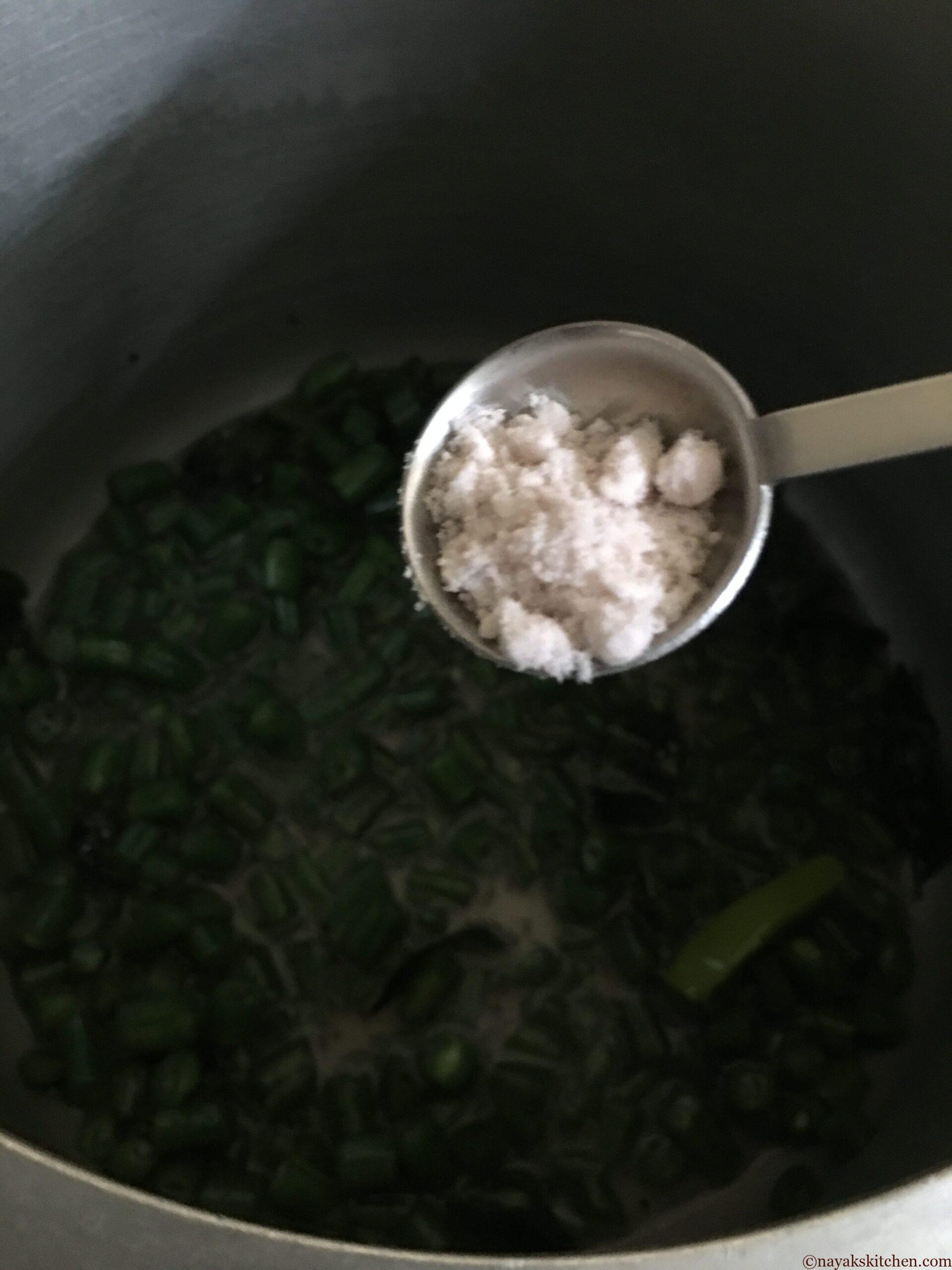 Adding salt to val papdichi bhaji