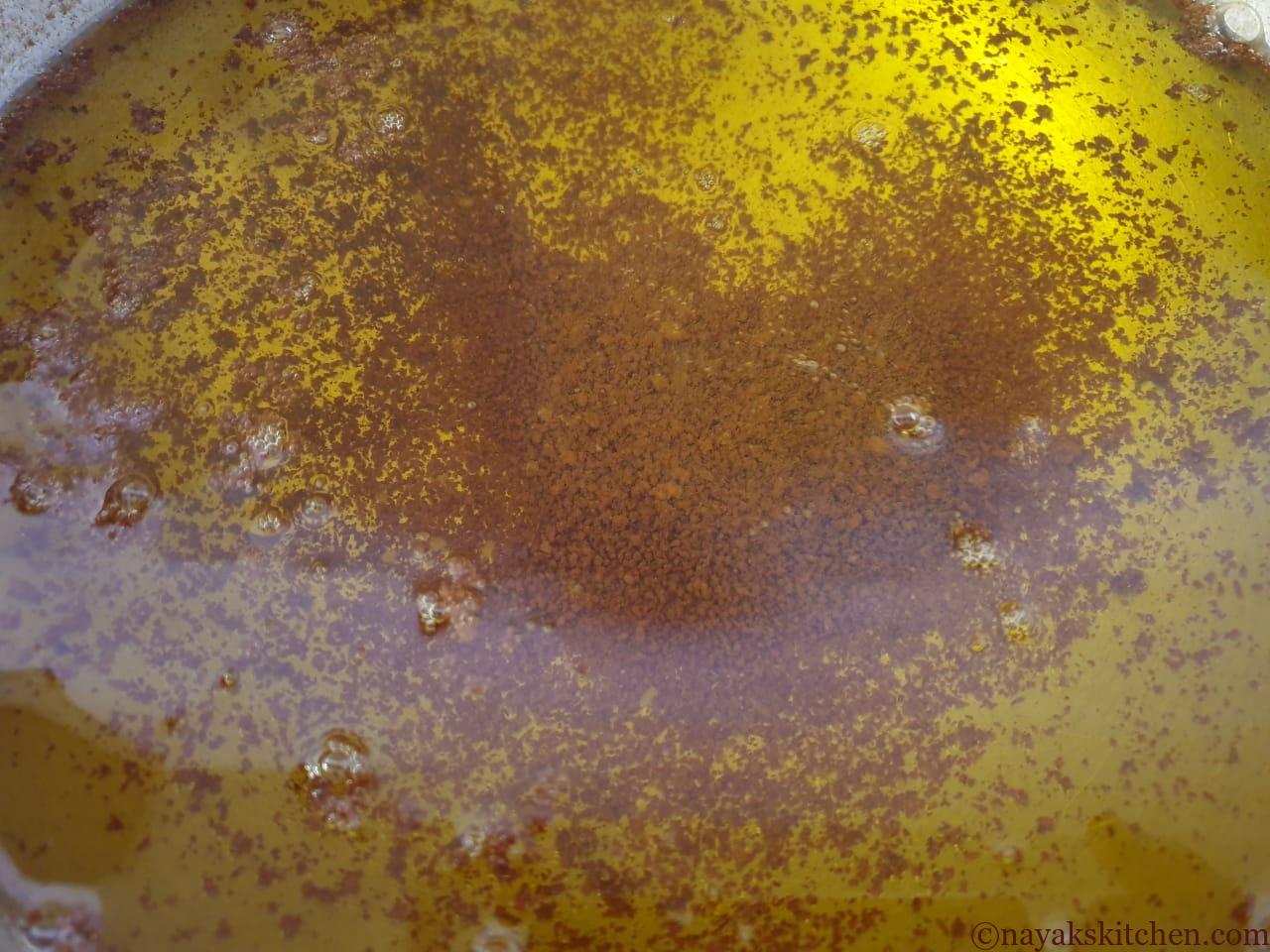 Pure ghee with browned milk solids settled at the bottom