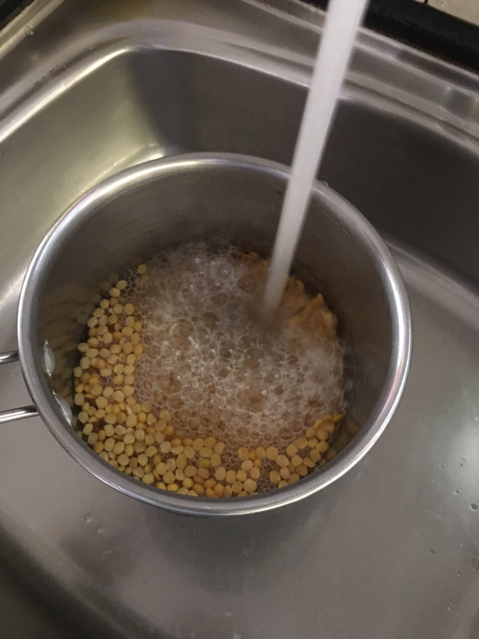 Washing tur dal with water