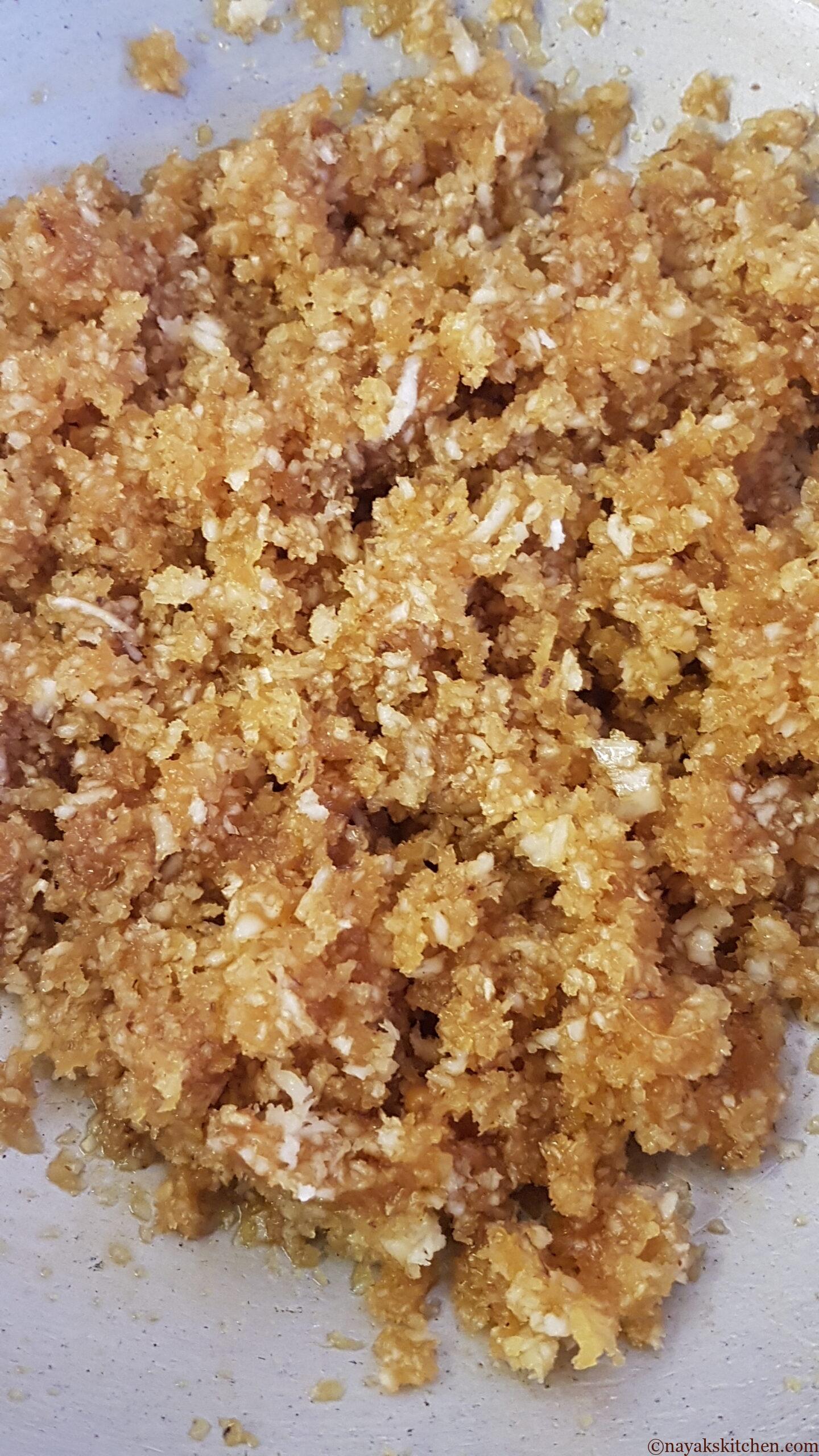 Mixing coconut and jaggery well