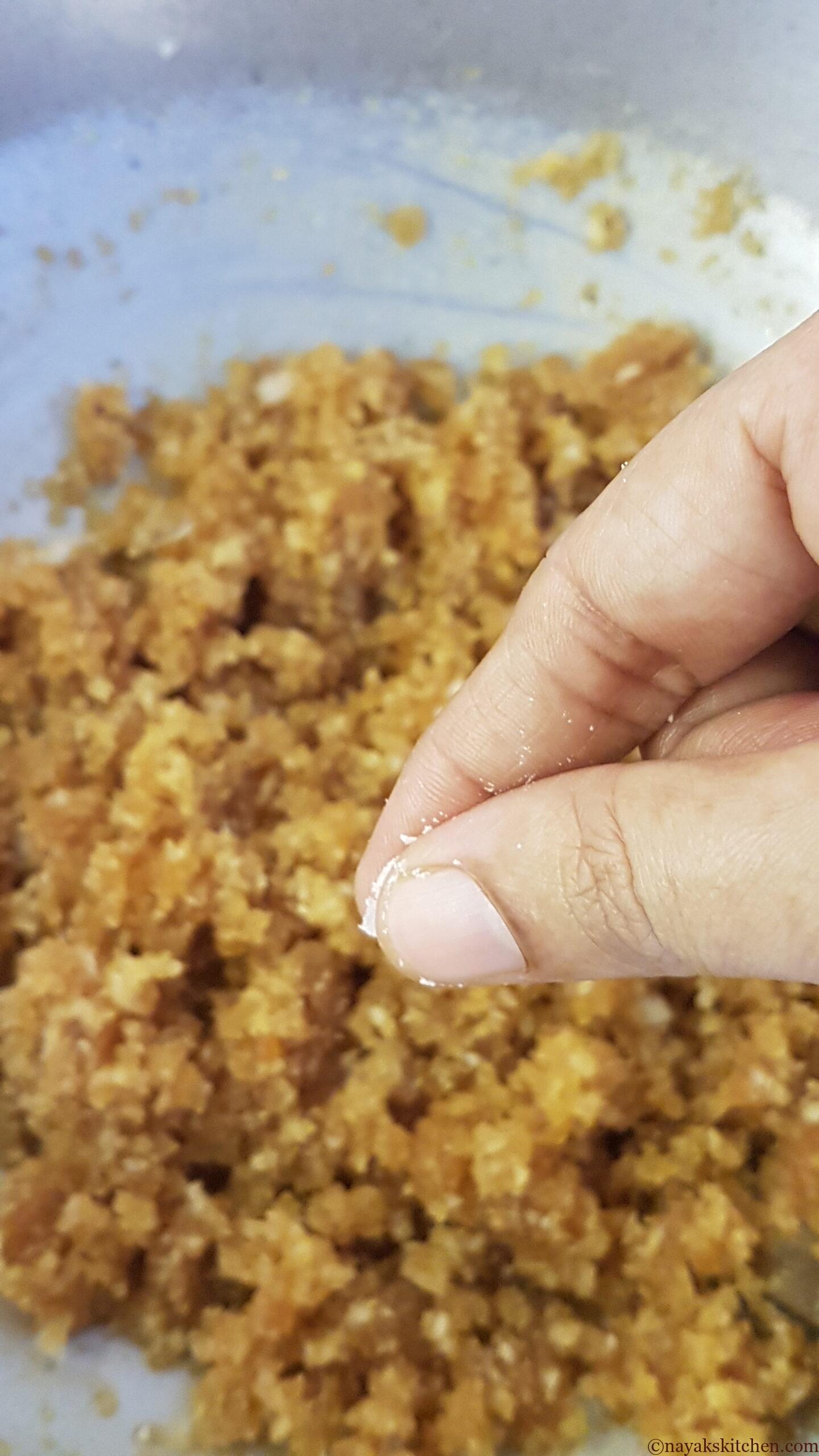 Adding salt to coconut jaggery mixture for patoli recipe
