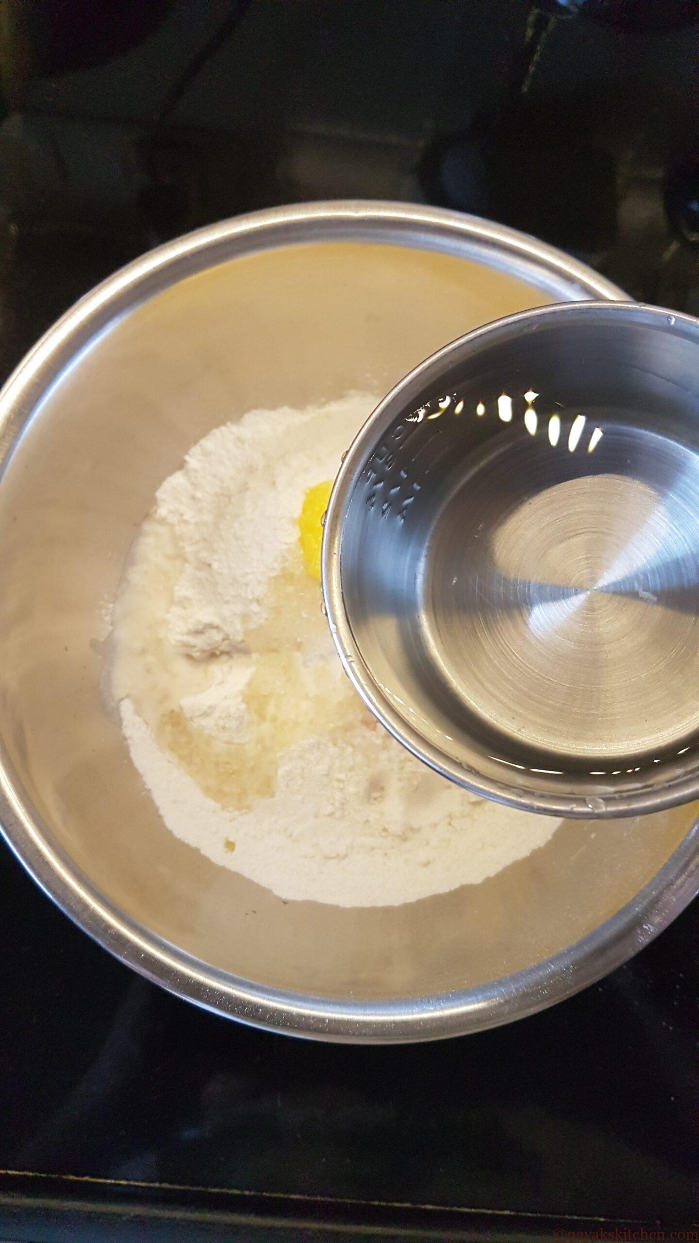 Adding water slowly to make a thick paste