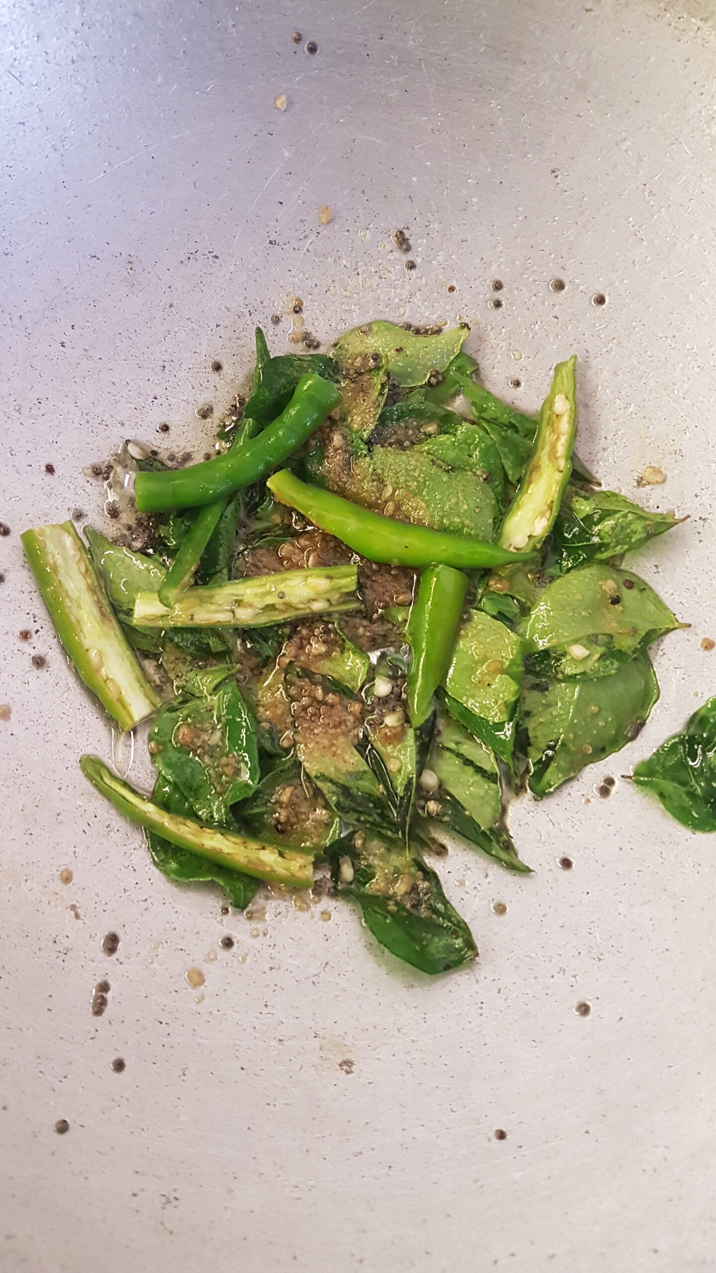 Adding slit green chillies