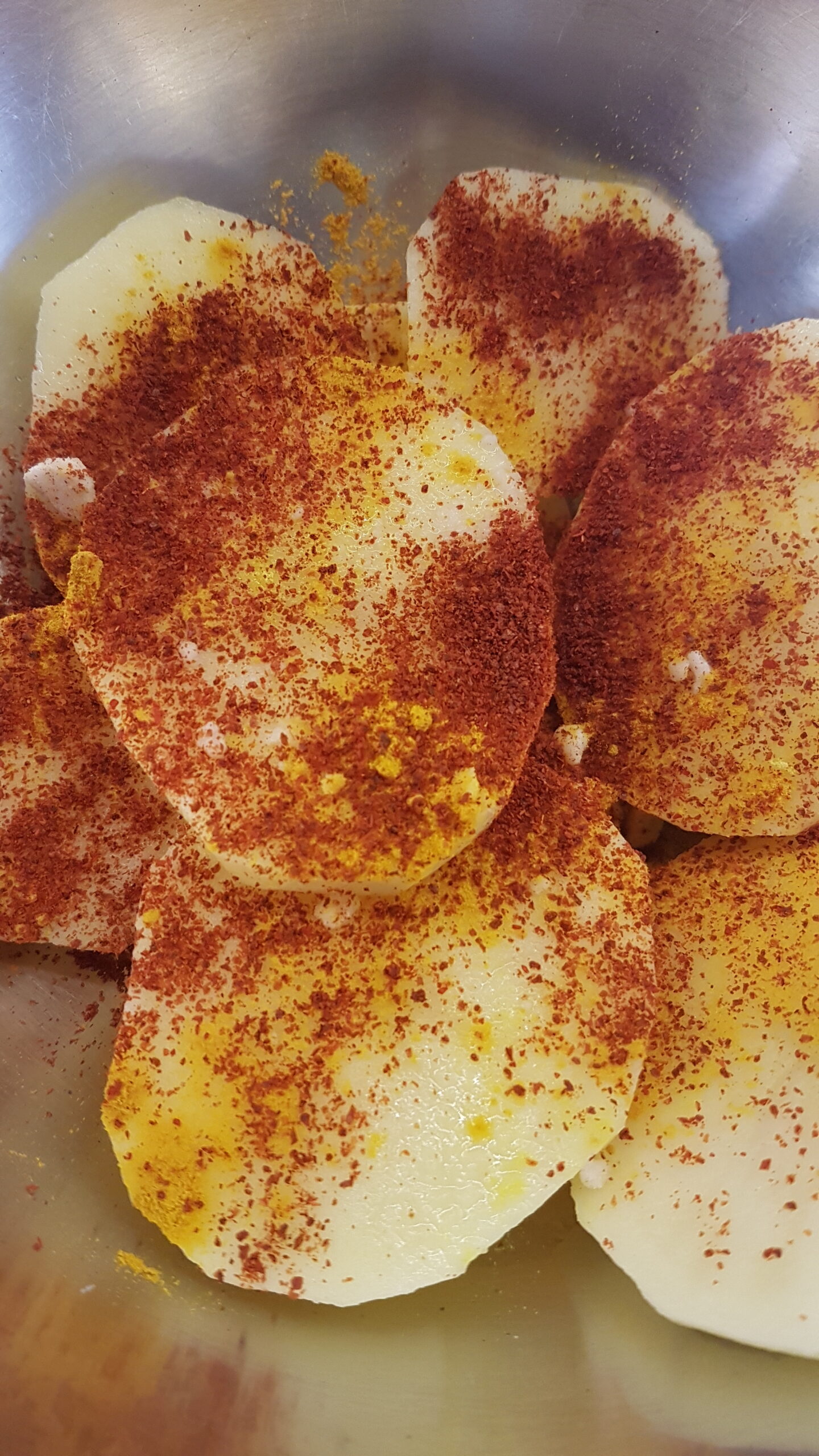 Adding chilli powder to batat fodi
