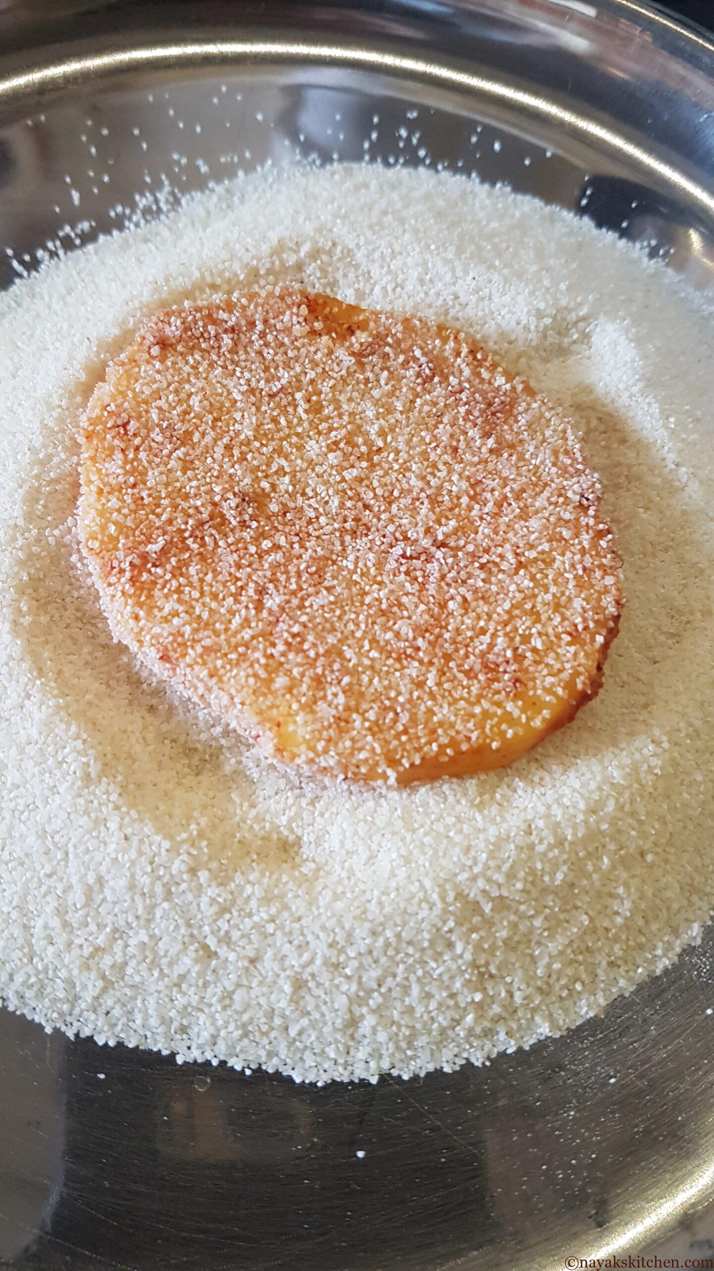 Coating batat fodi (potato slices) with rava or semolina