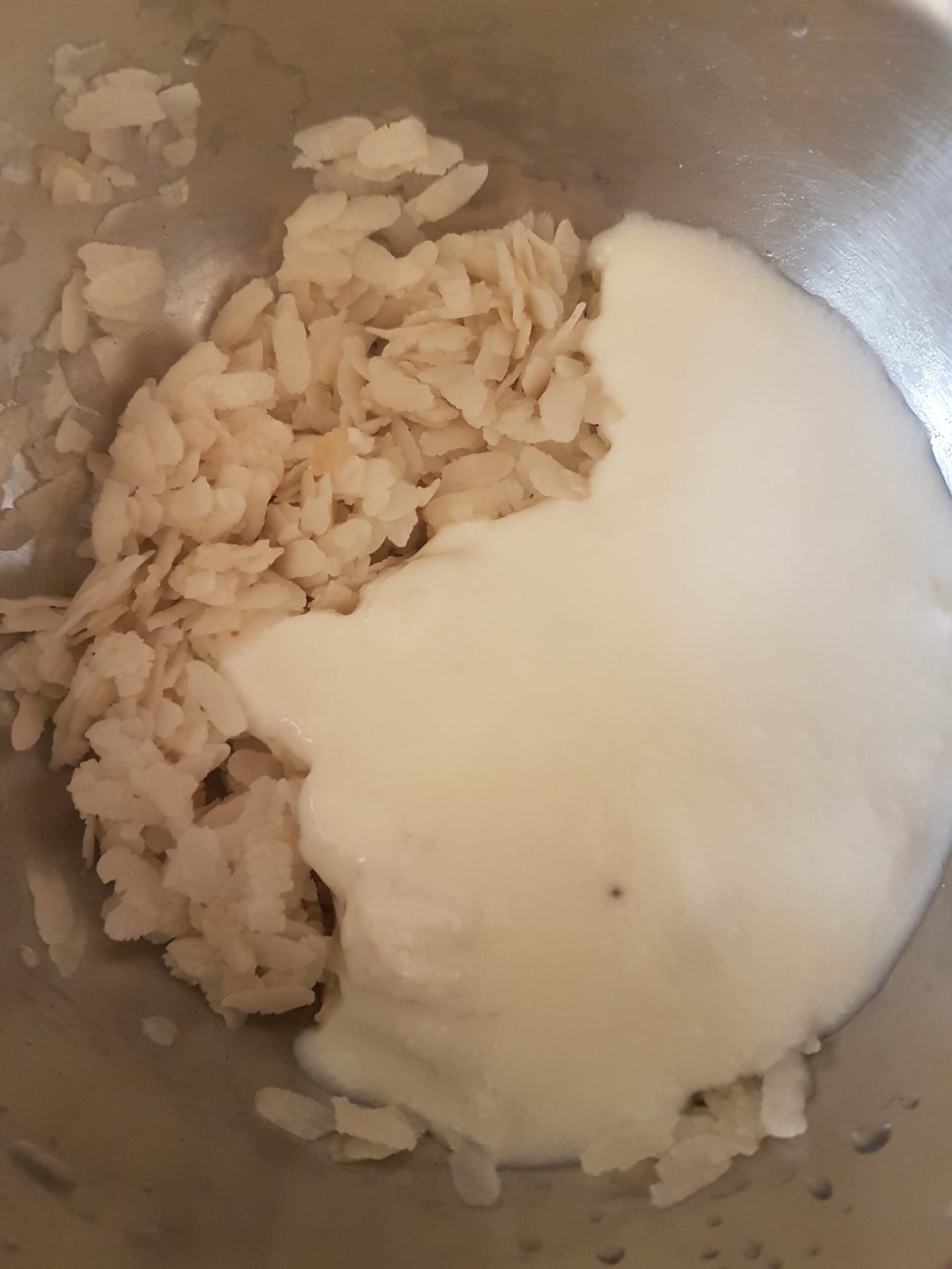 Adding curd to washed beaten rice