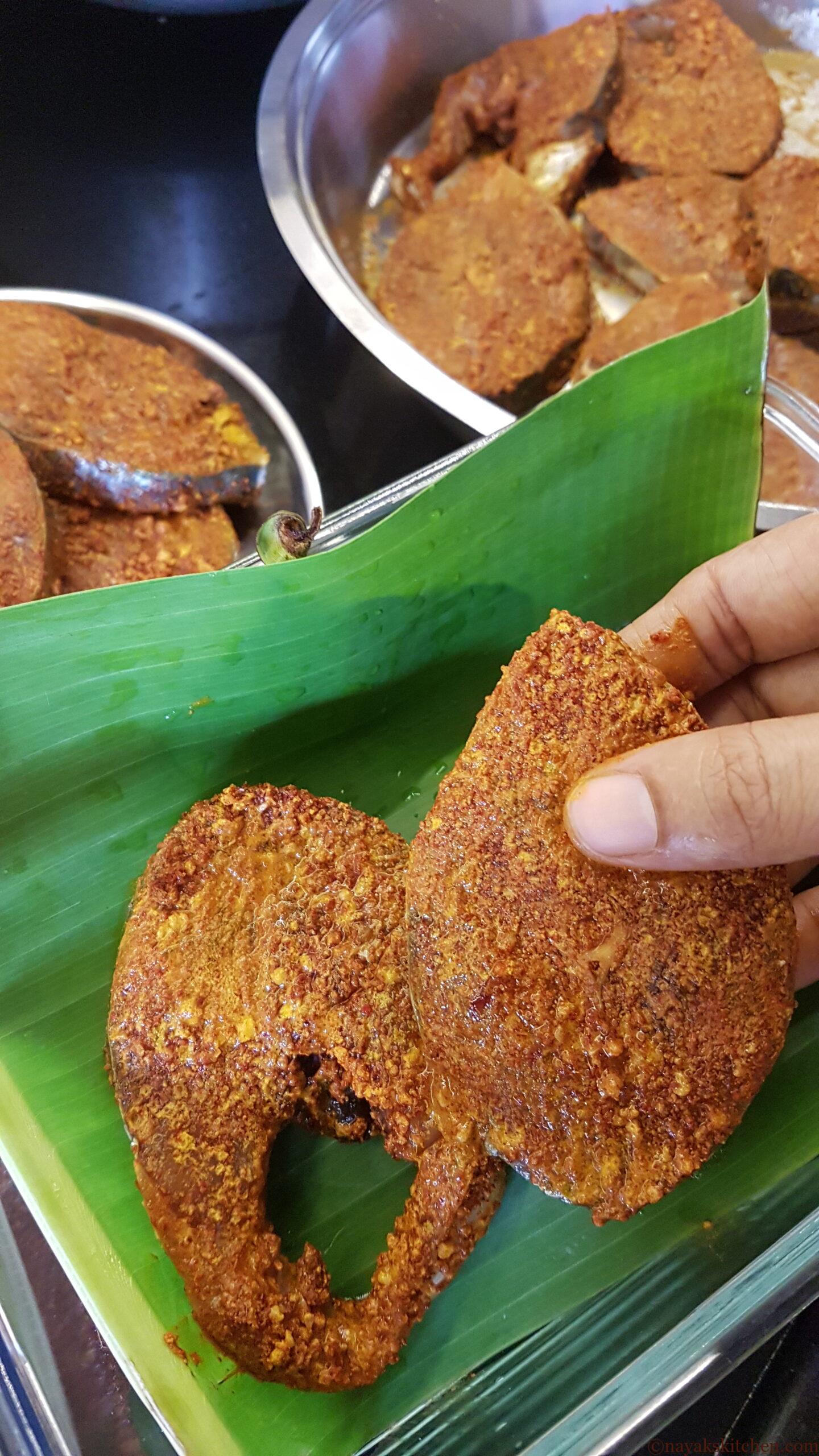 Placing fish in banana leaves for storing