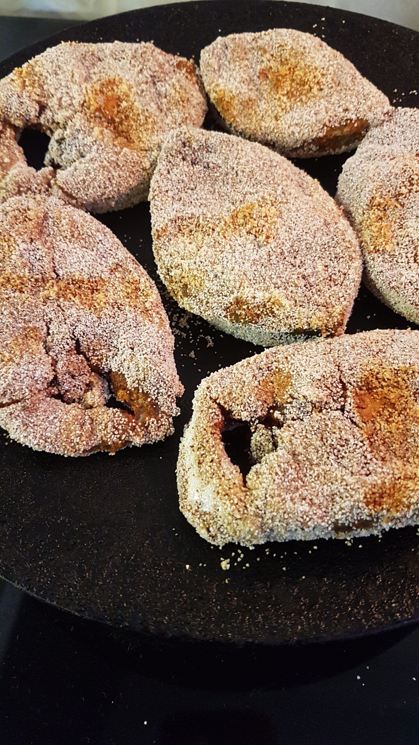 Frying fish on an iron tawa