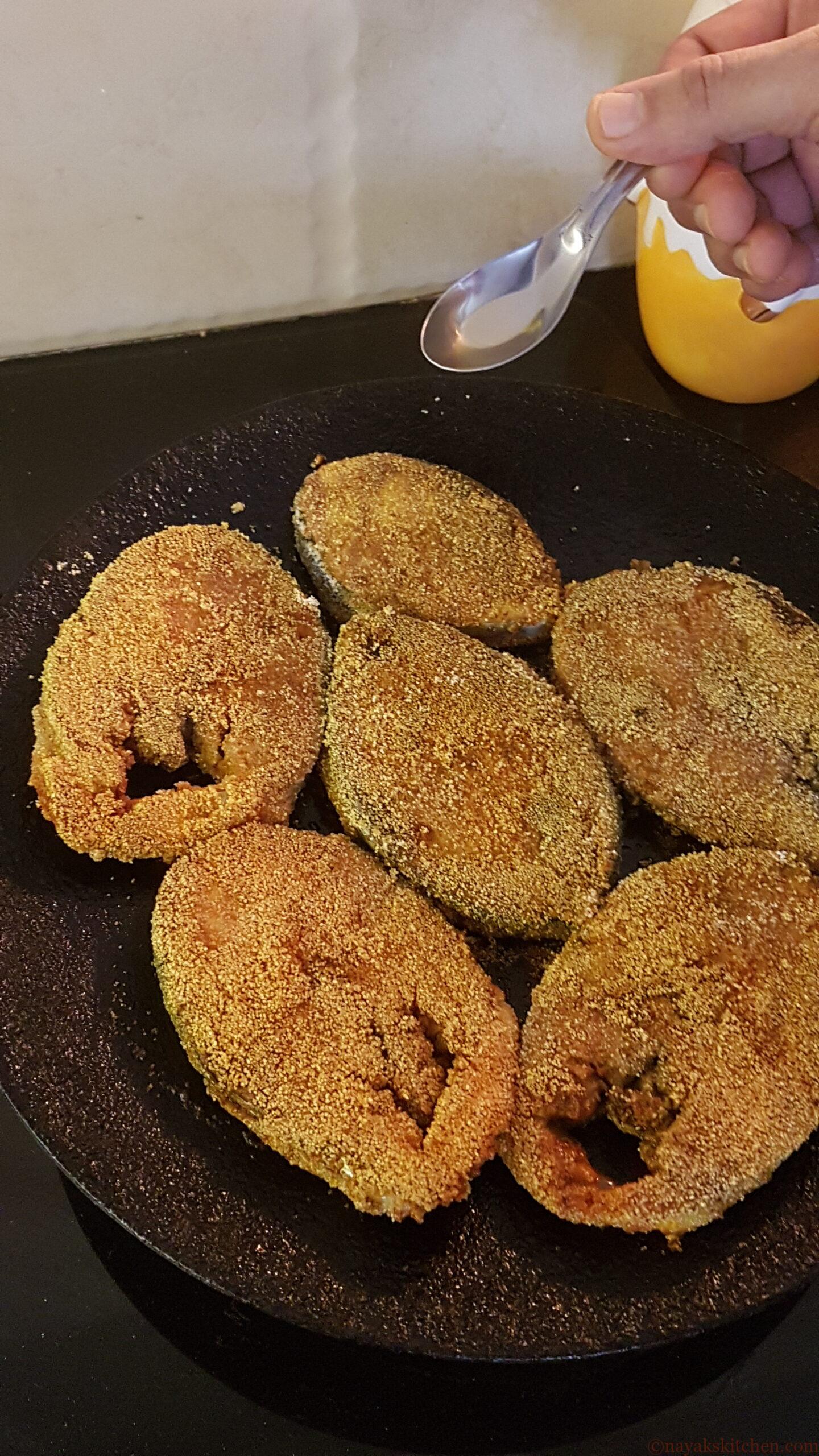 Pouring oil along the sides of fish