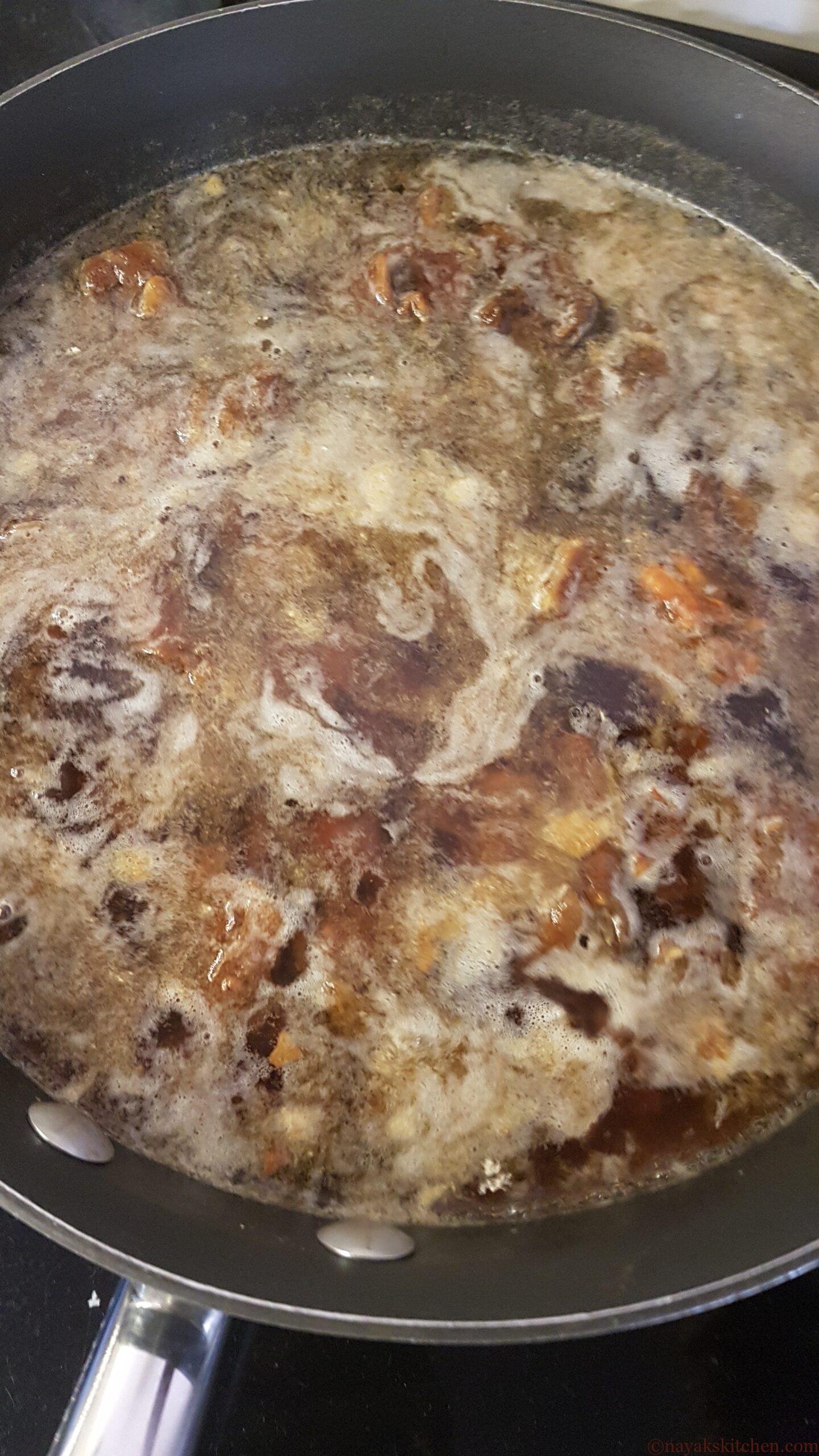 Bringing tamarind, dates and jaggery to a boil