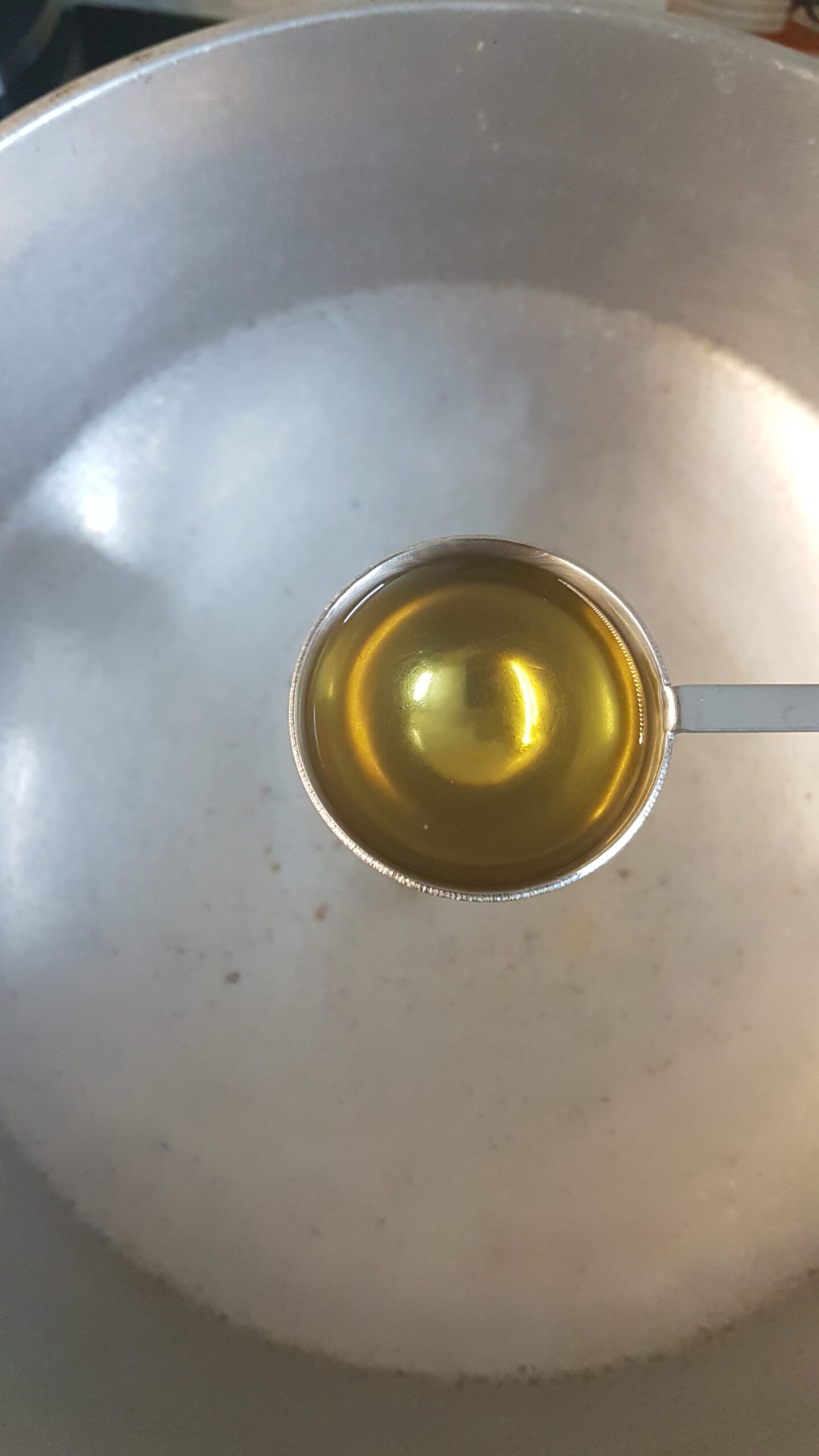 Adding oil to a kadhai (wok)