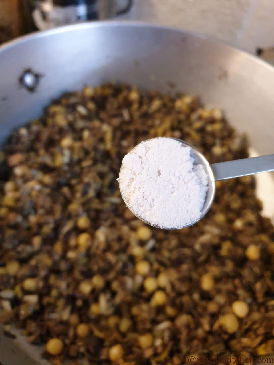 Adding salt to kelfulachi bhaji