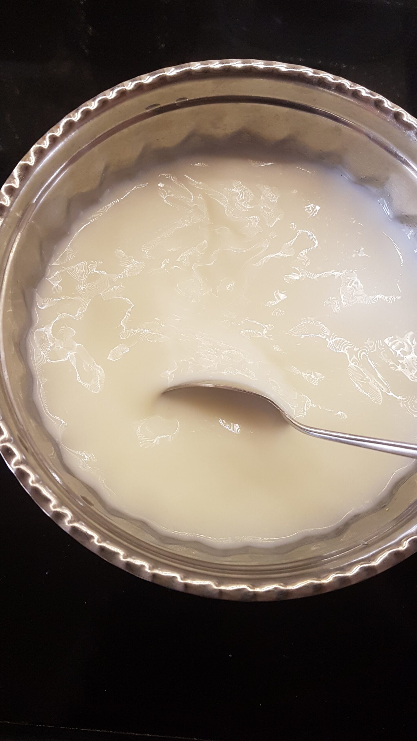 Stirring milk to dissolve sugar
