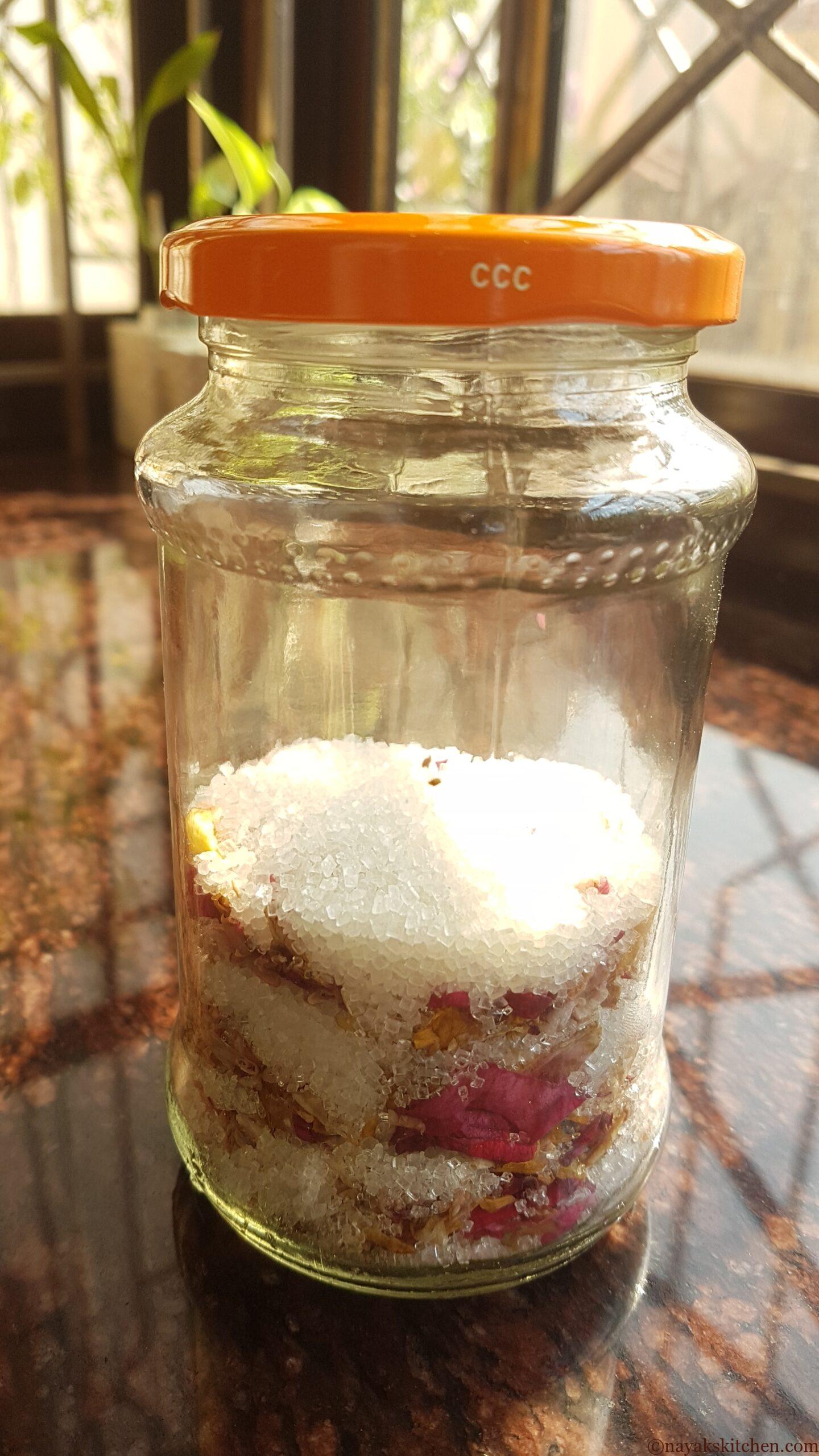 Sun-drying layered rose petals and sugar