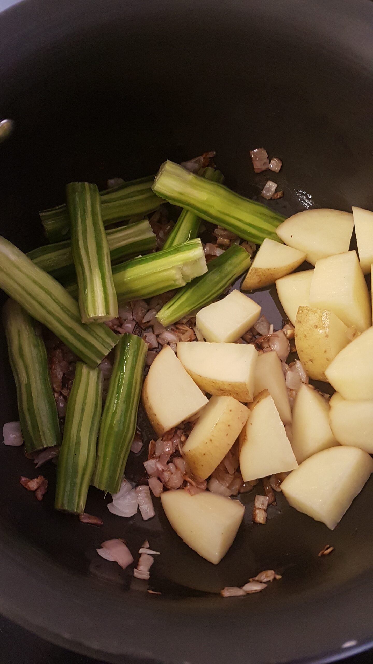 Adding drumsticks and potatoes