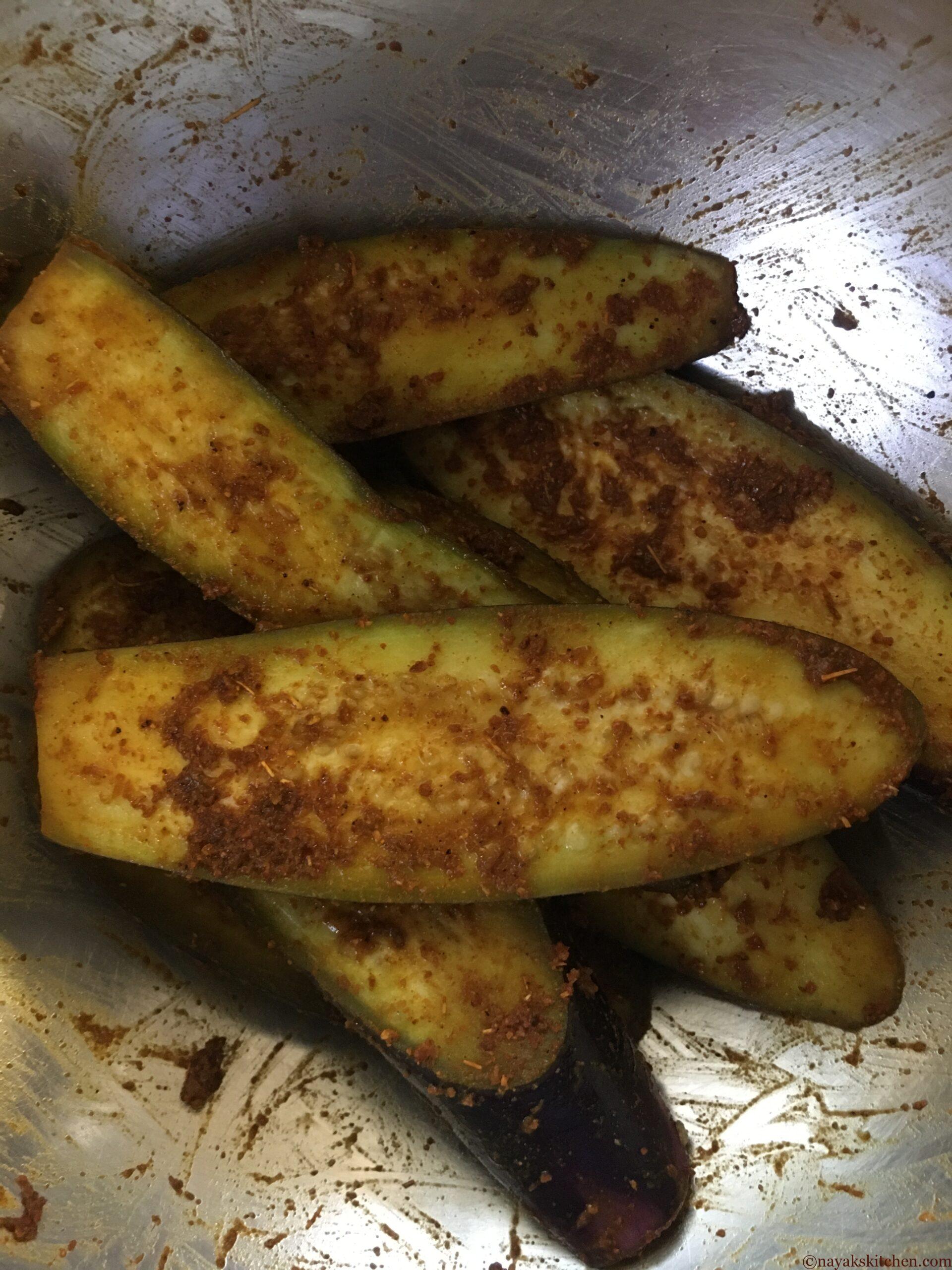 Coating brinjal pieces with spices