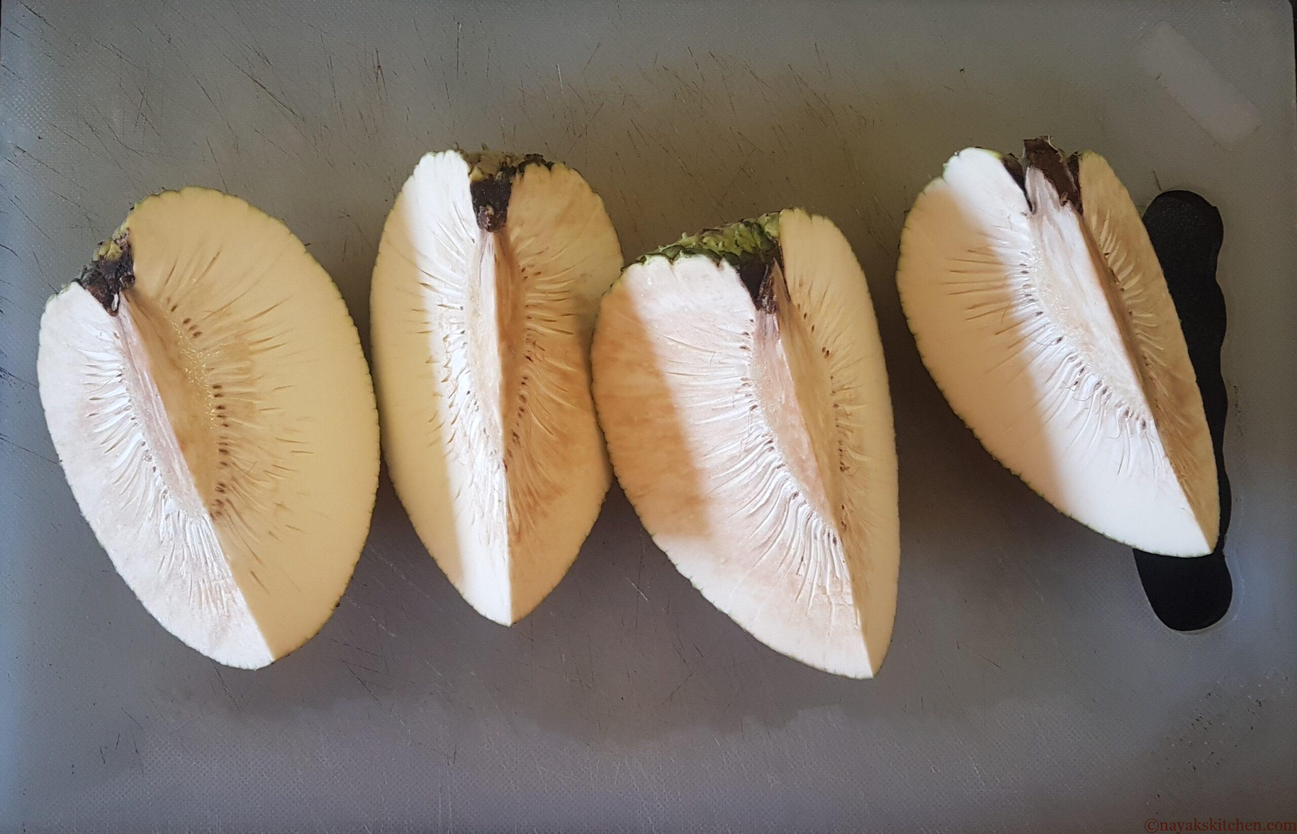 Cut the breadfruit further into quarters