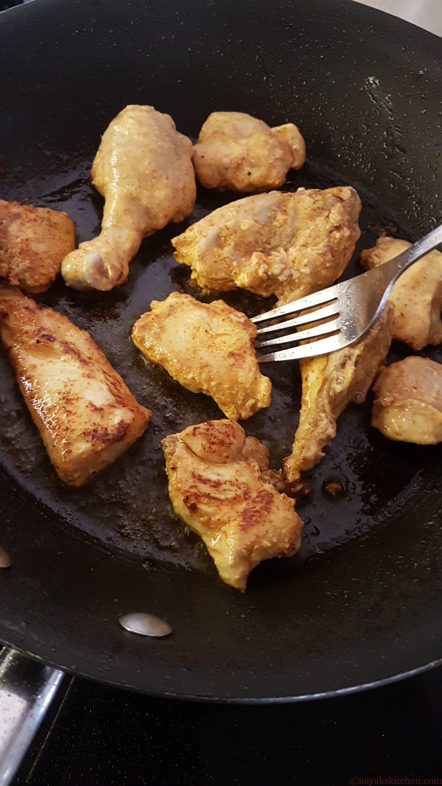 Flipping chicken using a fork to fry other side