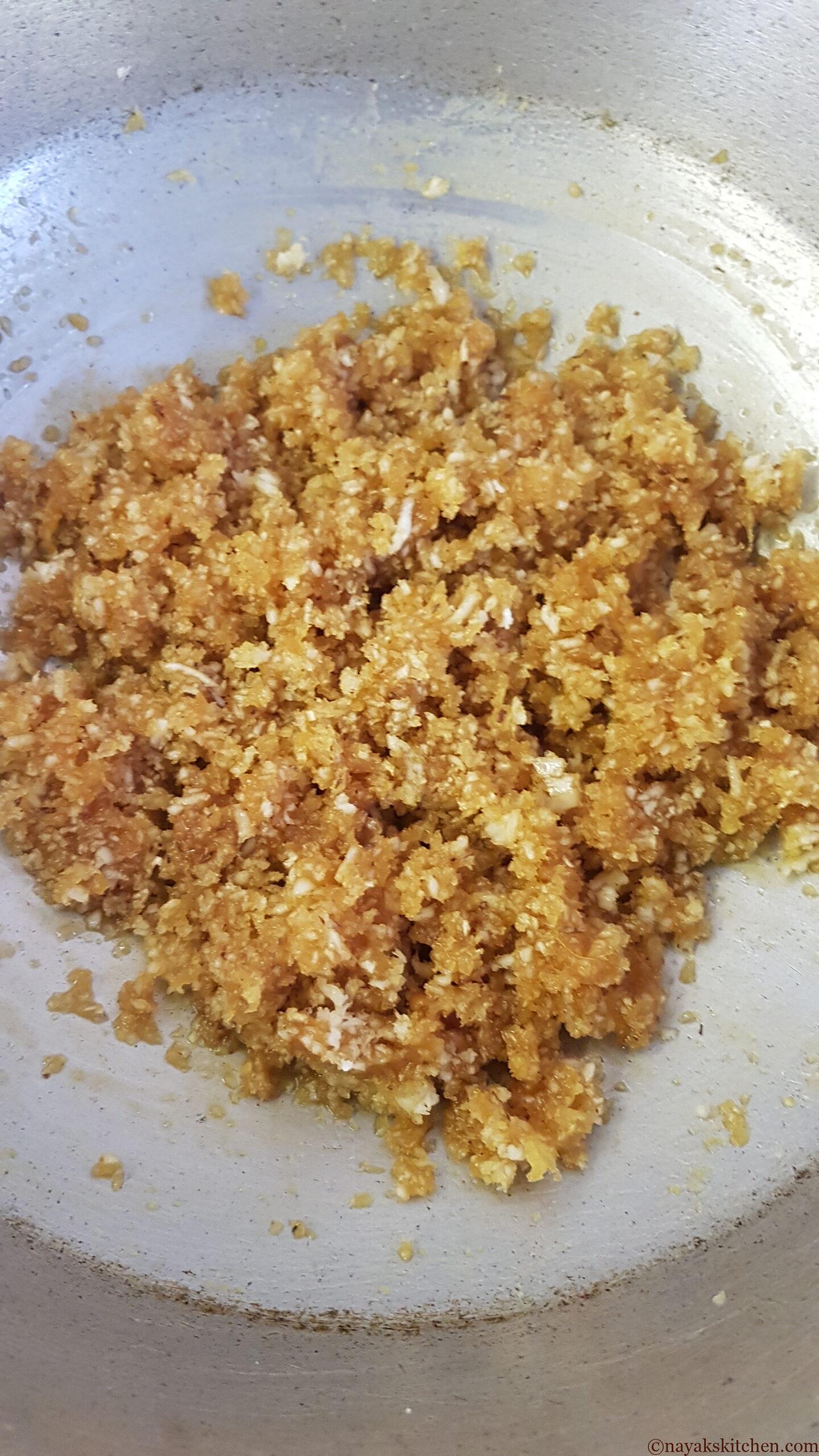 Mixing jaggery and coconut well