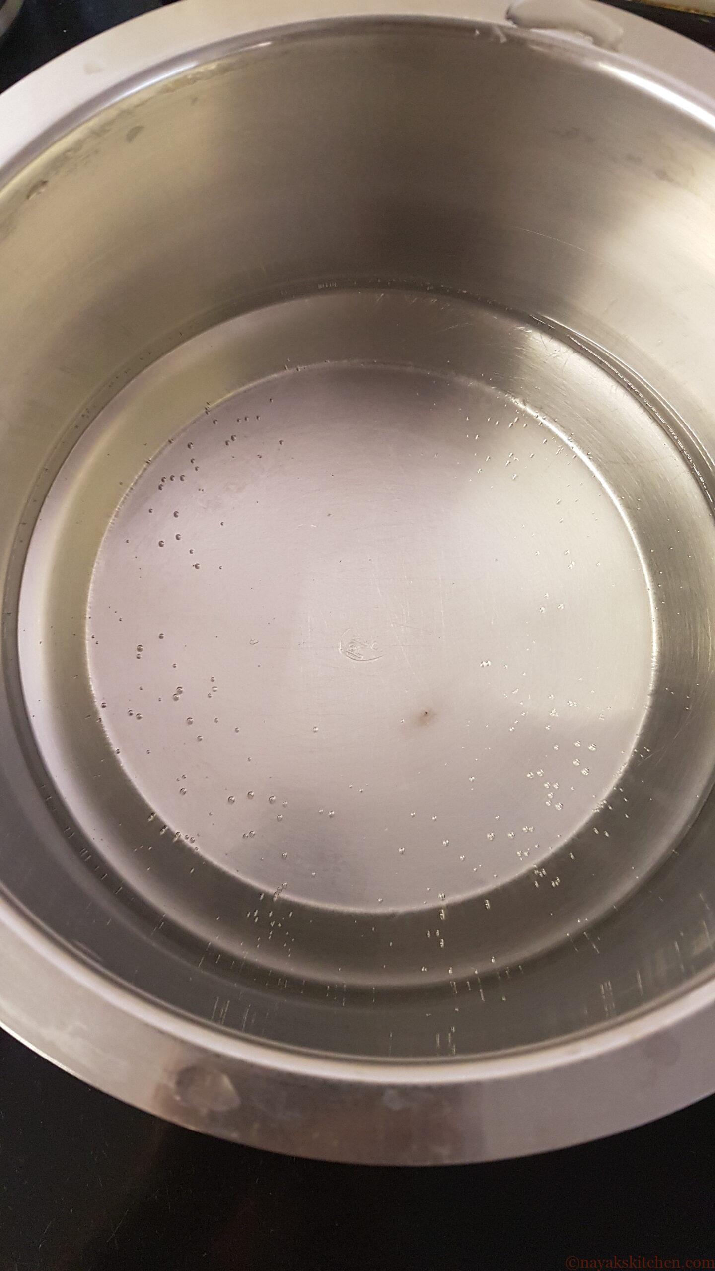 Heating water to prepare ukdiche modak