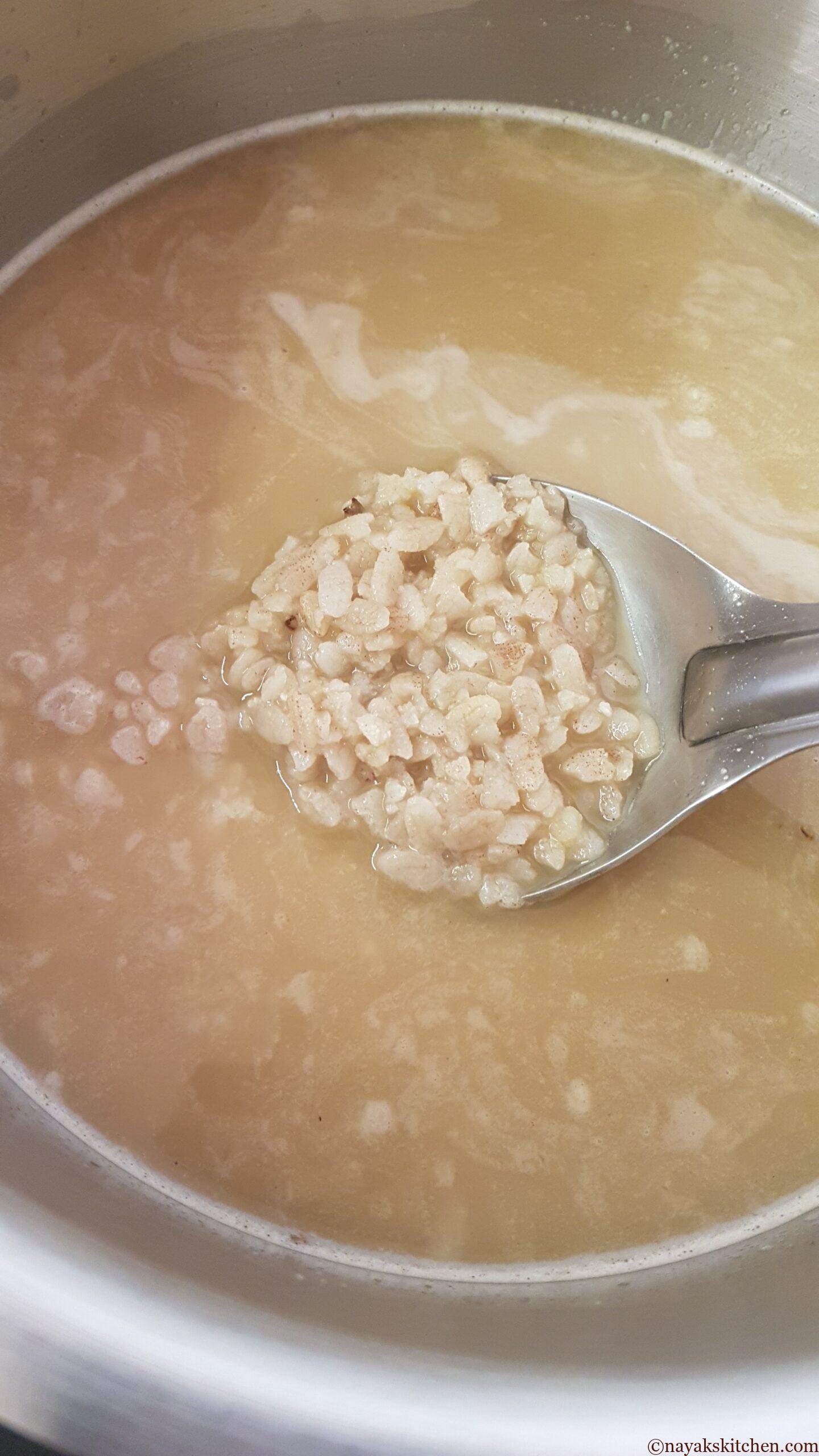 Stirring the coconut milk, jaggery, poha mixture well