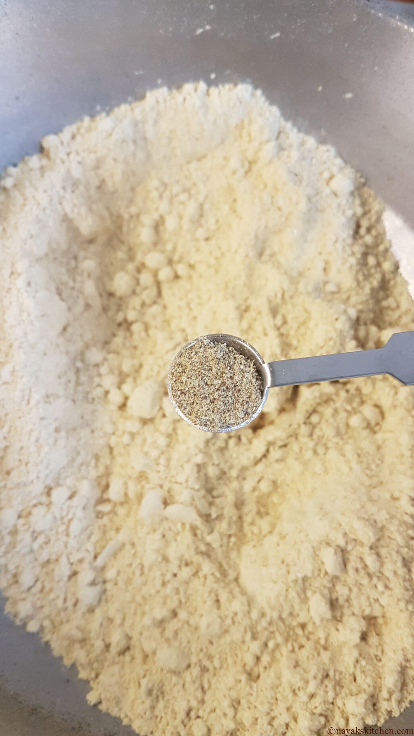 Adding cardamom powder to flour