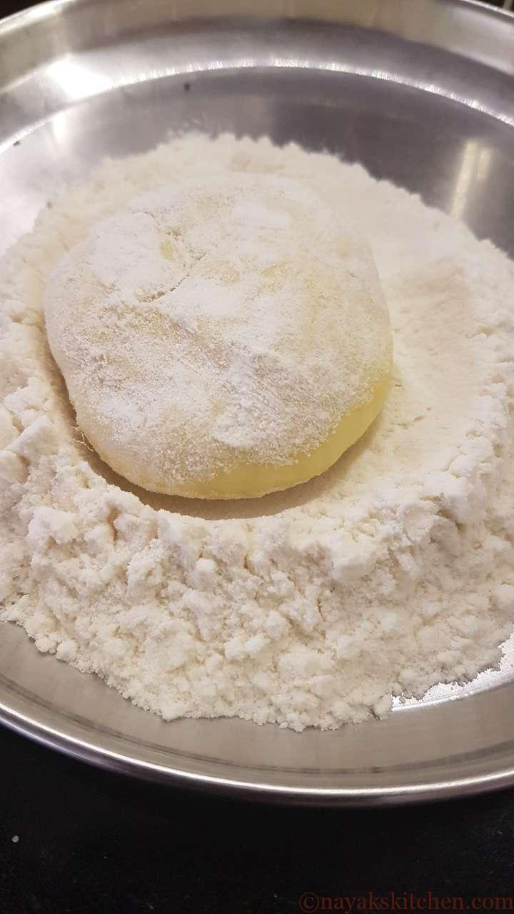 Coating maida ball with flour