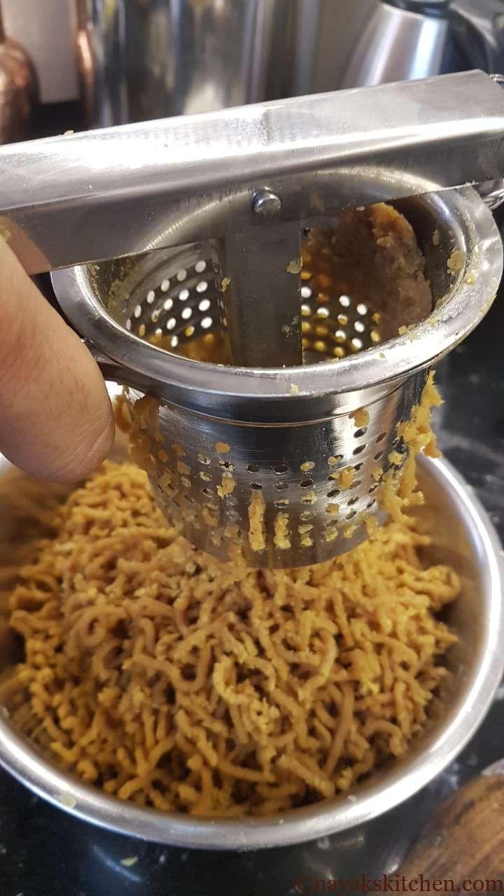 Squeezing puran through a potato masher