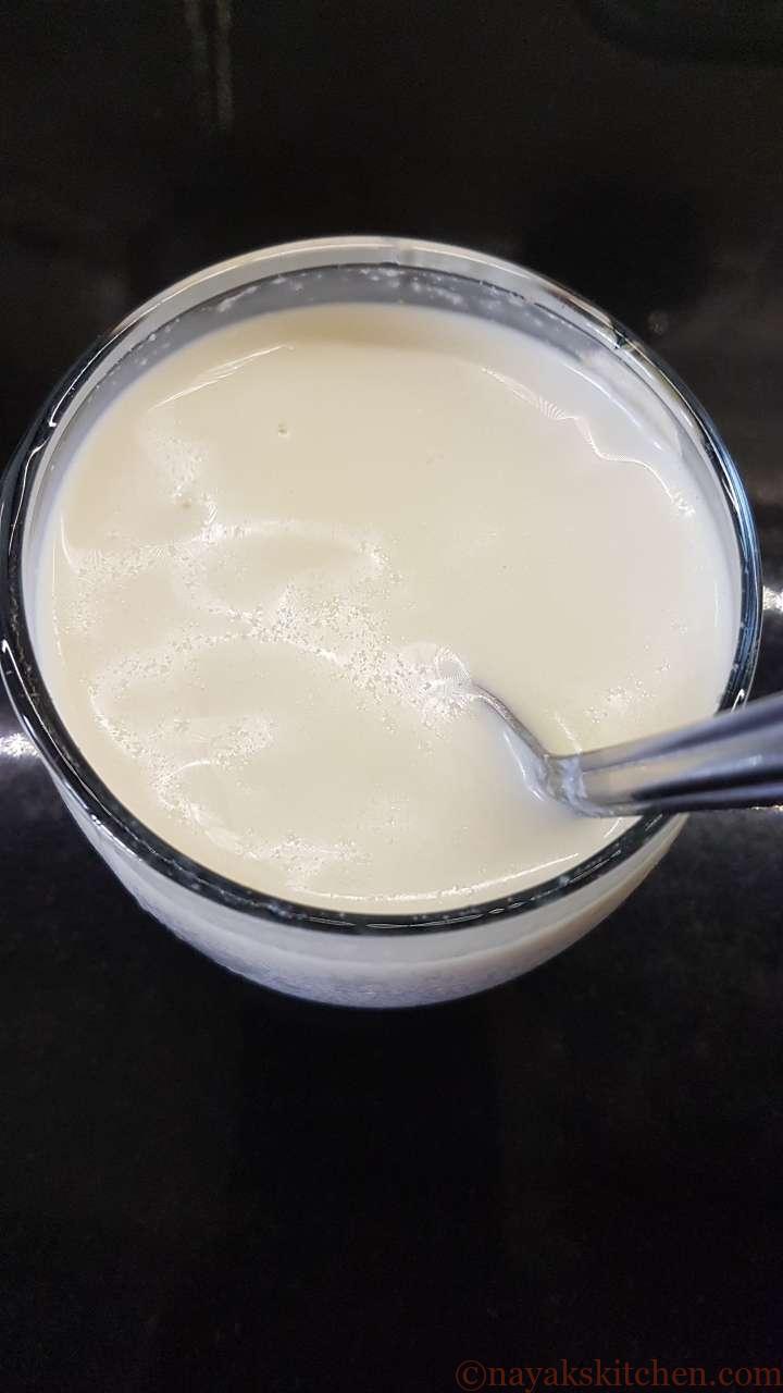 Stirring milk to dissolve gulkand