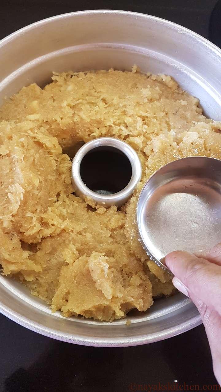 Levelling the mixture using the greased bowl