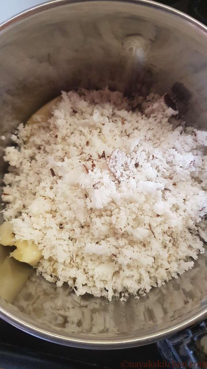 Adding grated coconut to jackfruit