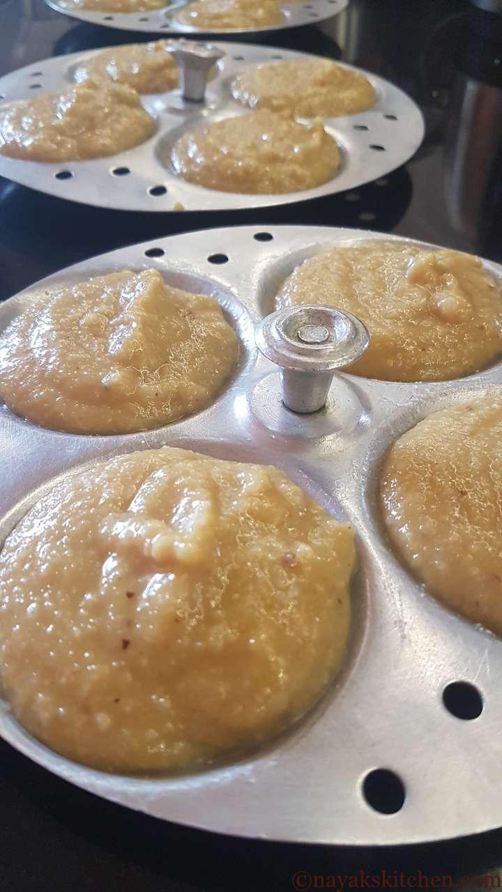 Pouring batter into greased idli plates