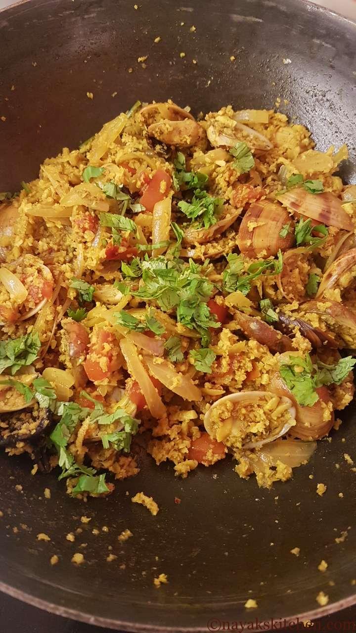 Adding green coriander to goan tisreo sukhem recipe