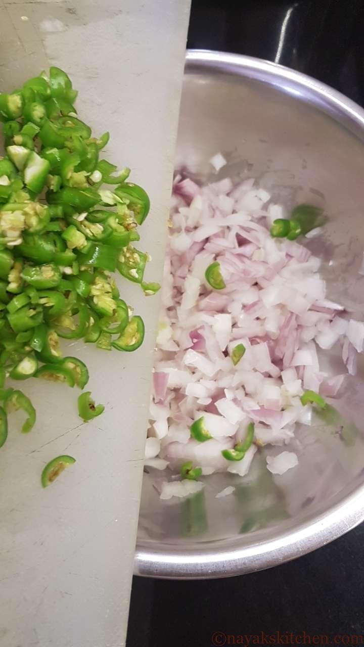Adding green chillies to chopped onion