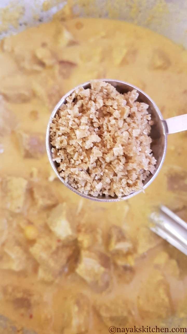 Adding salt to raw jackfruit curry