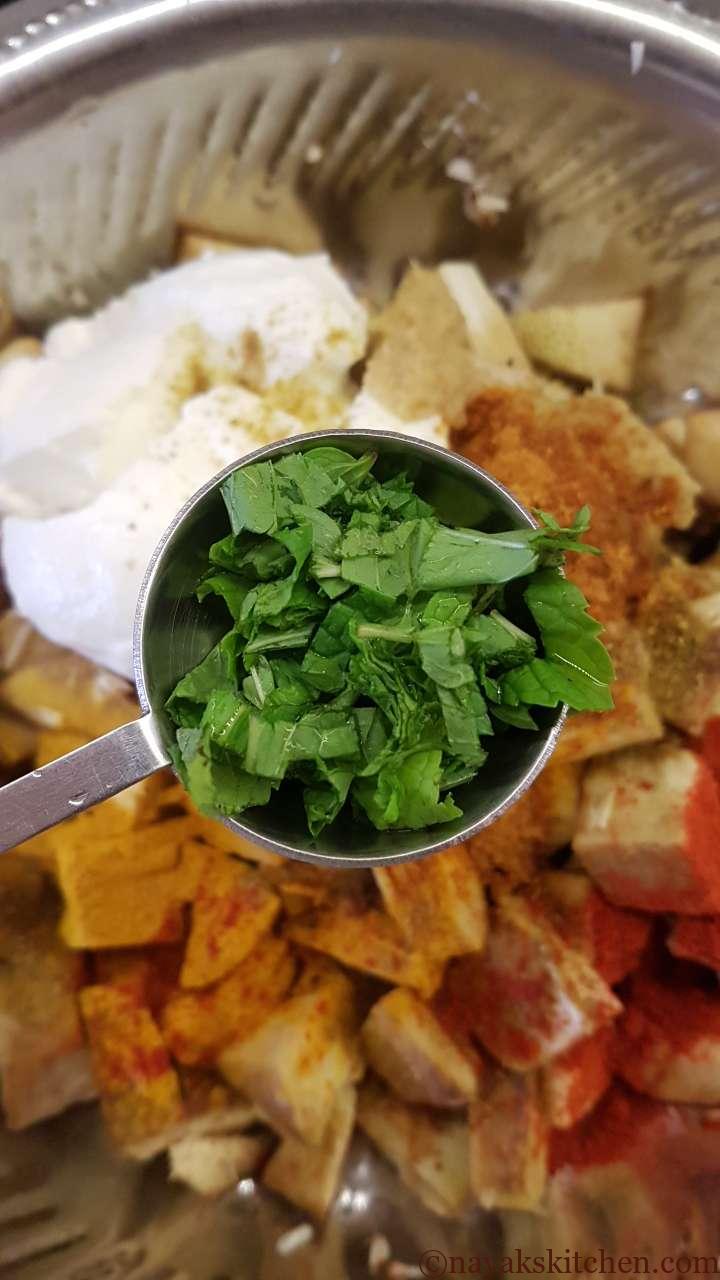 Adding mint leaves to jackfruit pieces
