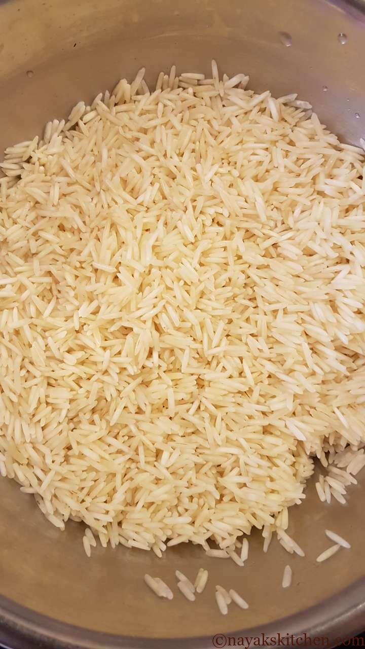 Draining the water from soaked rice