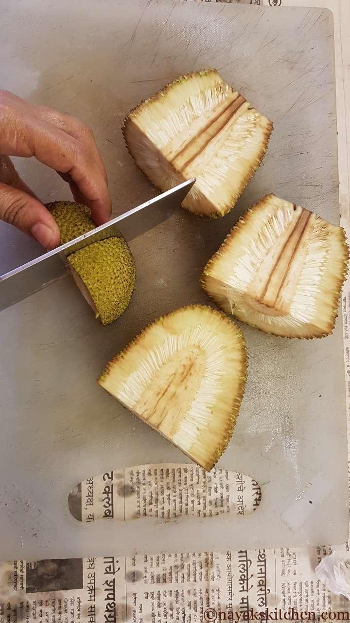 Cutting the quartered jackfruit further