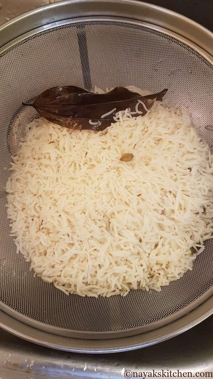 Straining rice in a colander