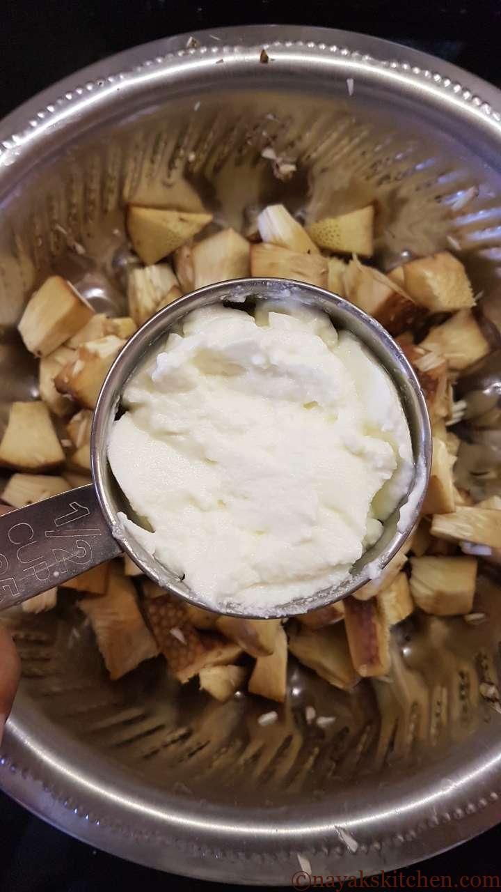 Adding curd to jackfruit pieces