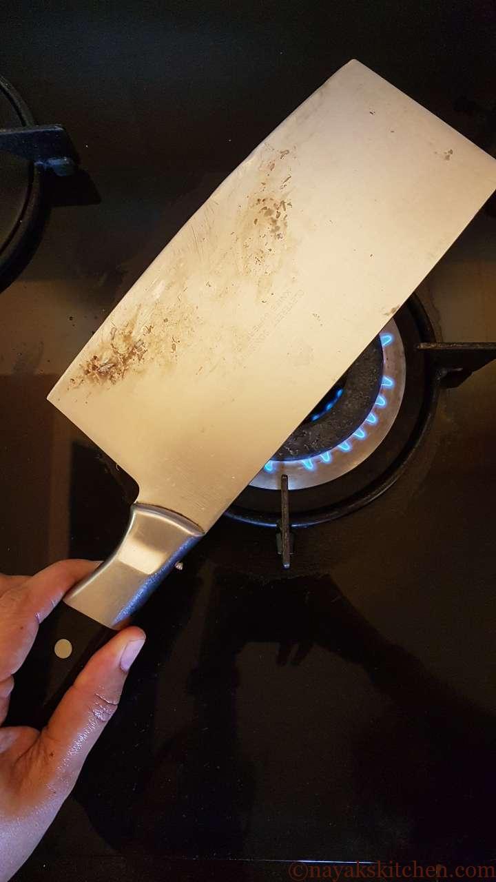 Warming the knife to clean the sap