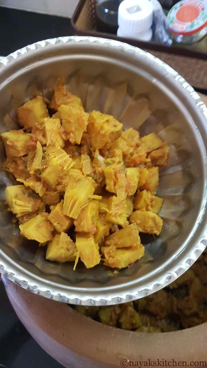 Removing half of the cooked jackfruit