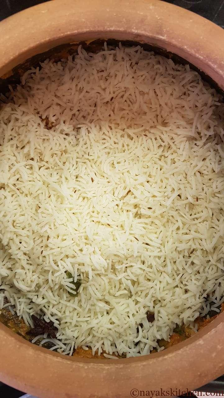 Adding a layer of basmati rice